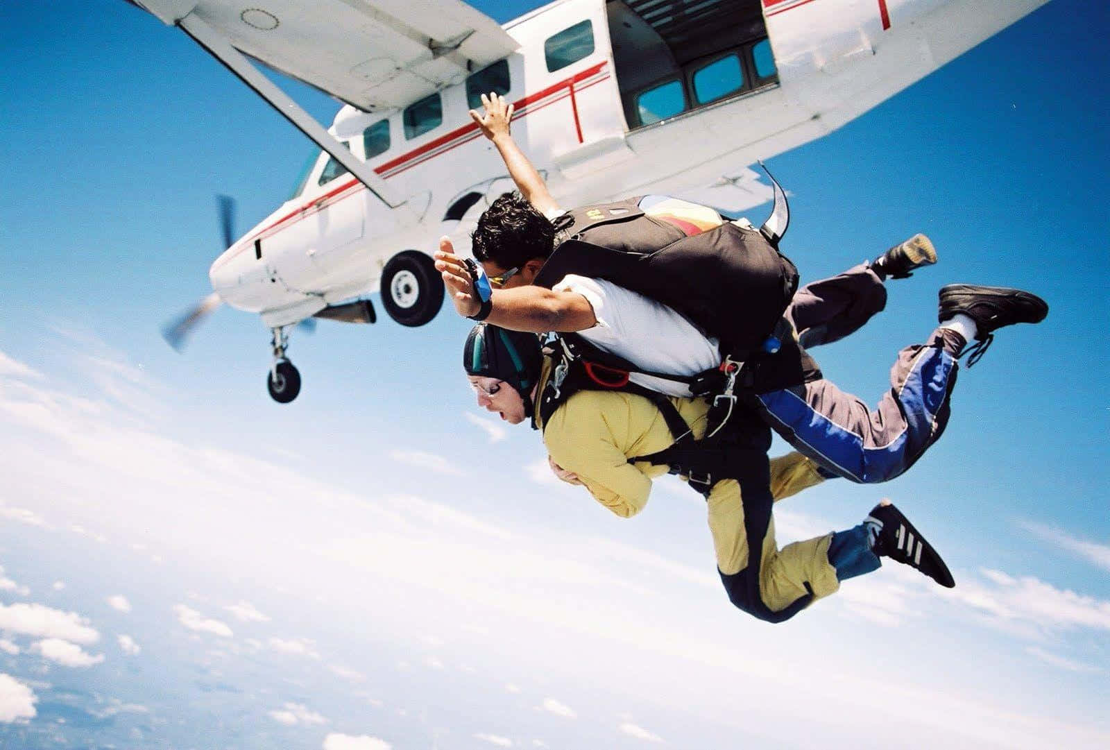 A Man And Woman Are Jumping From A Plane