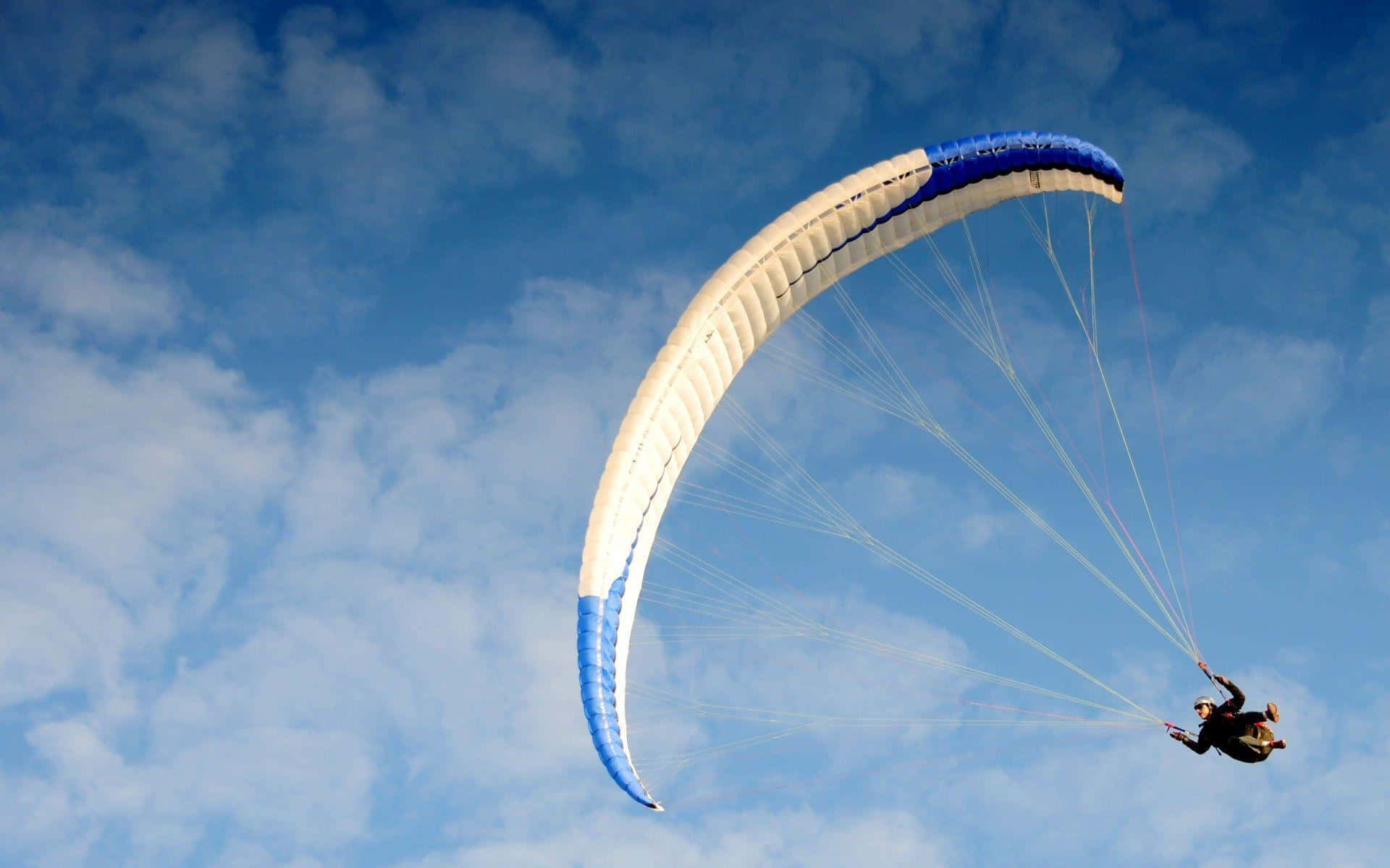 A Person Is Paragliding In The Sky