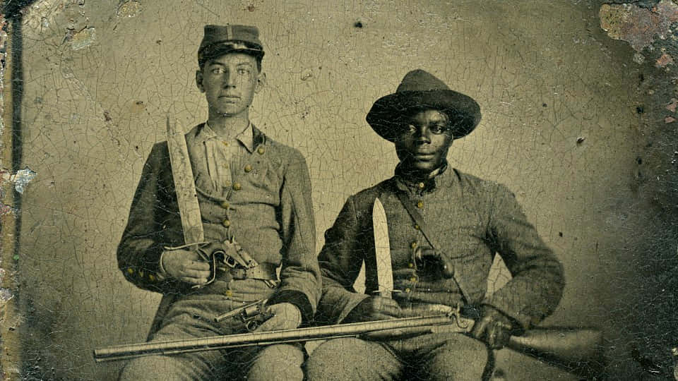 Two Men In Uniform Pose For A Photo