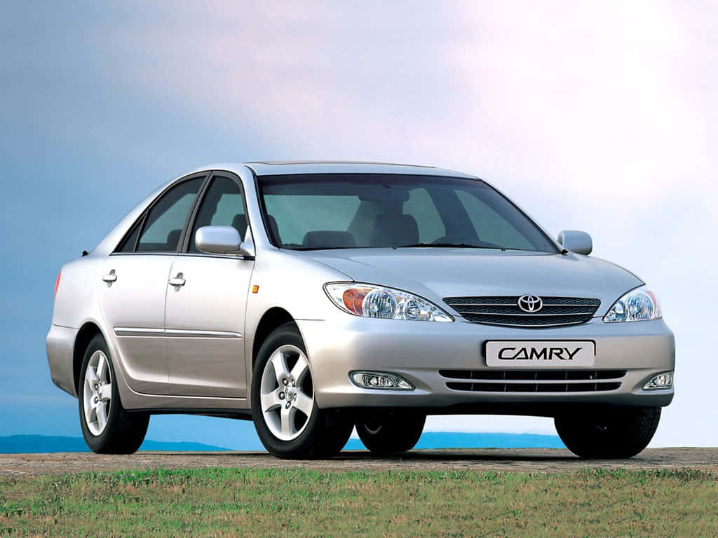 Sleek 2021 Toyota Camry Gliding On The Road Wallpaper