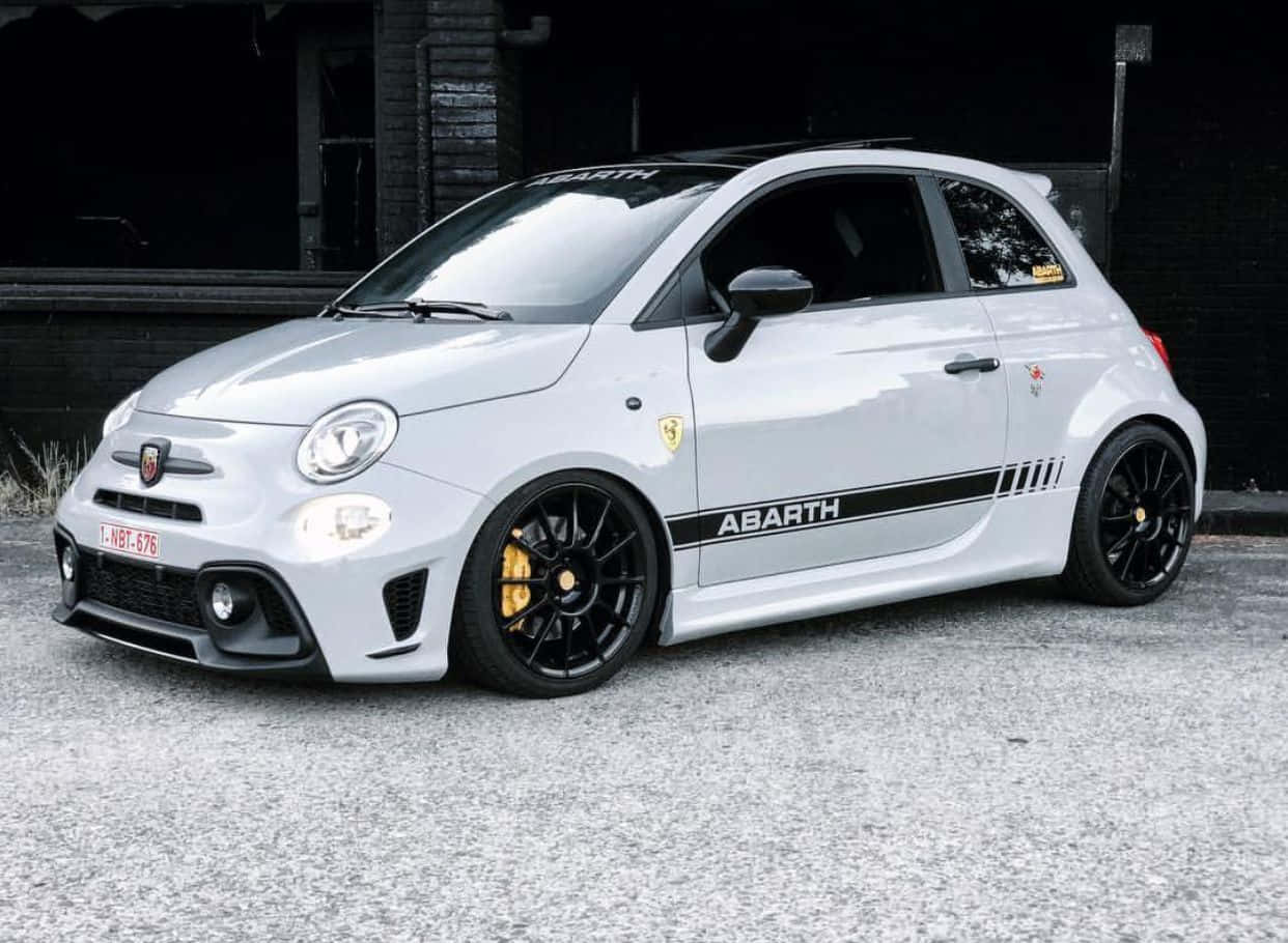 Sleek Abarth 595 Racing On The Road Wallpaper