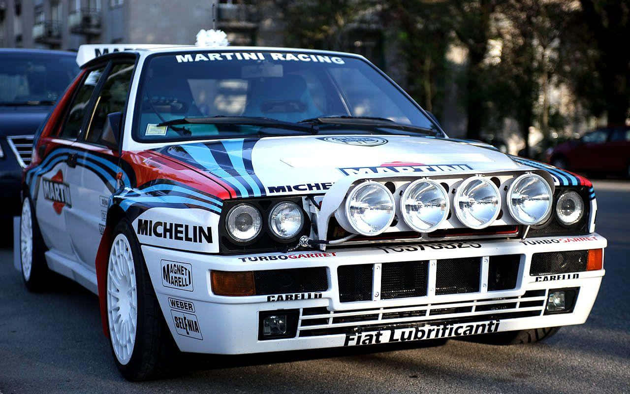 Sleek And Elite Lancia Delta In Action Wallpaper