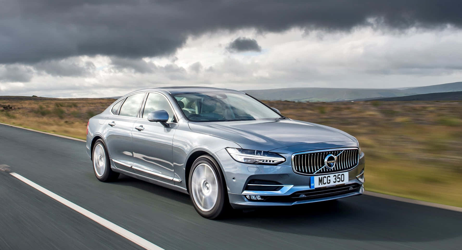 Sleek And Luxurious Volvo S90 On Open Road Wallpaper
