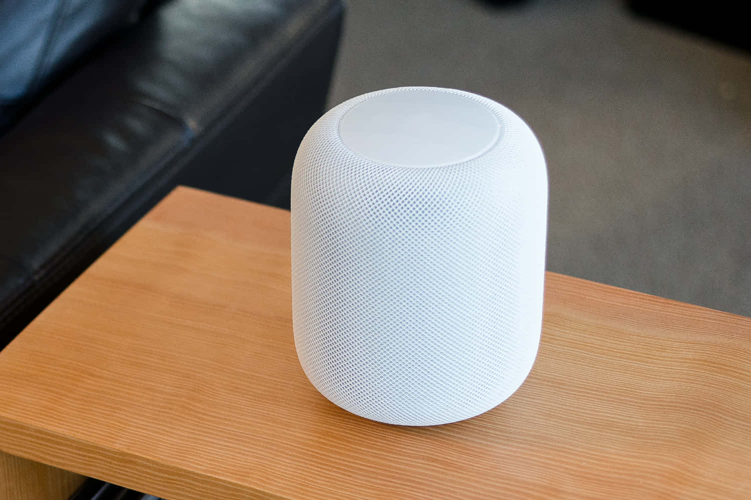 Sleek And Modern Apple Homepod On A Wooden Table Wallpaper