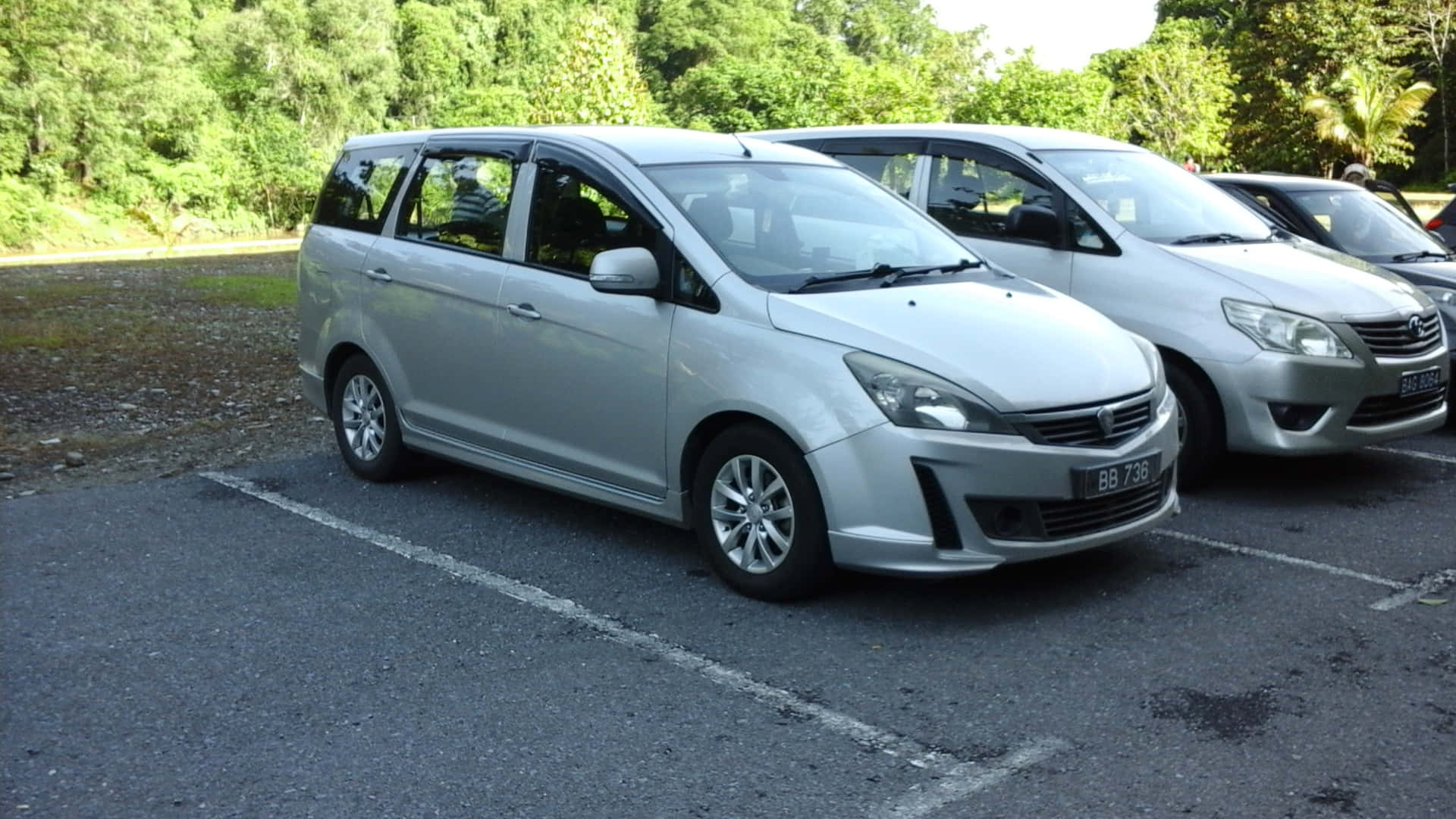 Sleek And Modern Proton Exora Cruising On The City Streets. Wallpaper