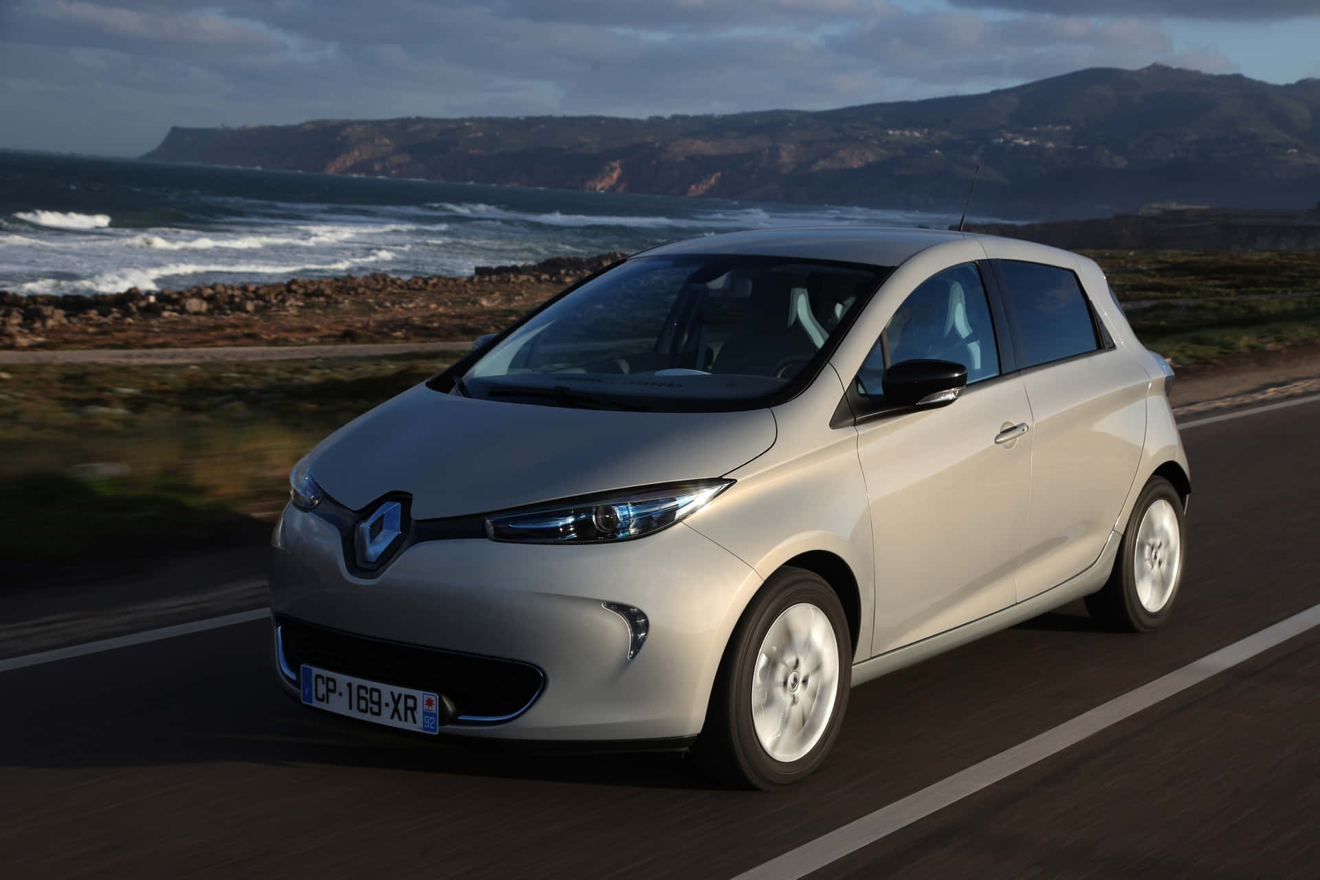 Sleek And Modern Renault Zoe Posed Against Scenic Backdrop Wallpaper