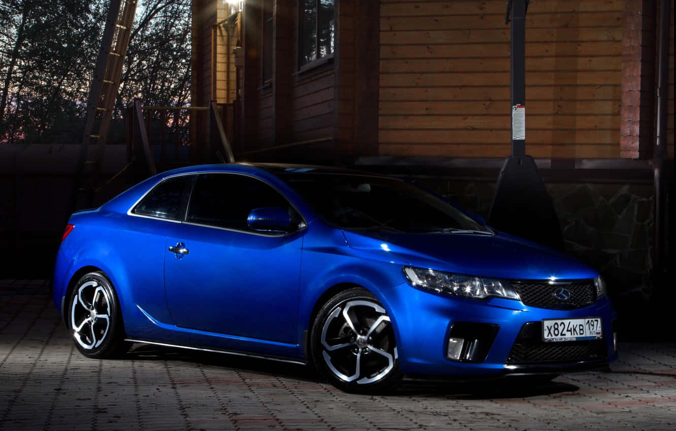 Sleek And Polished Red Kia Forte In The Spotlight. Wallpaper