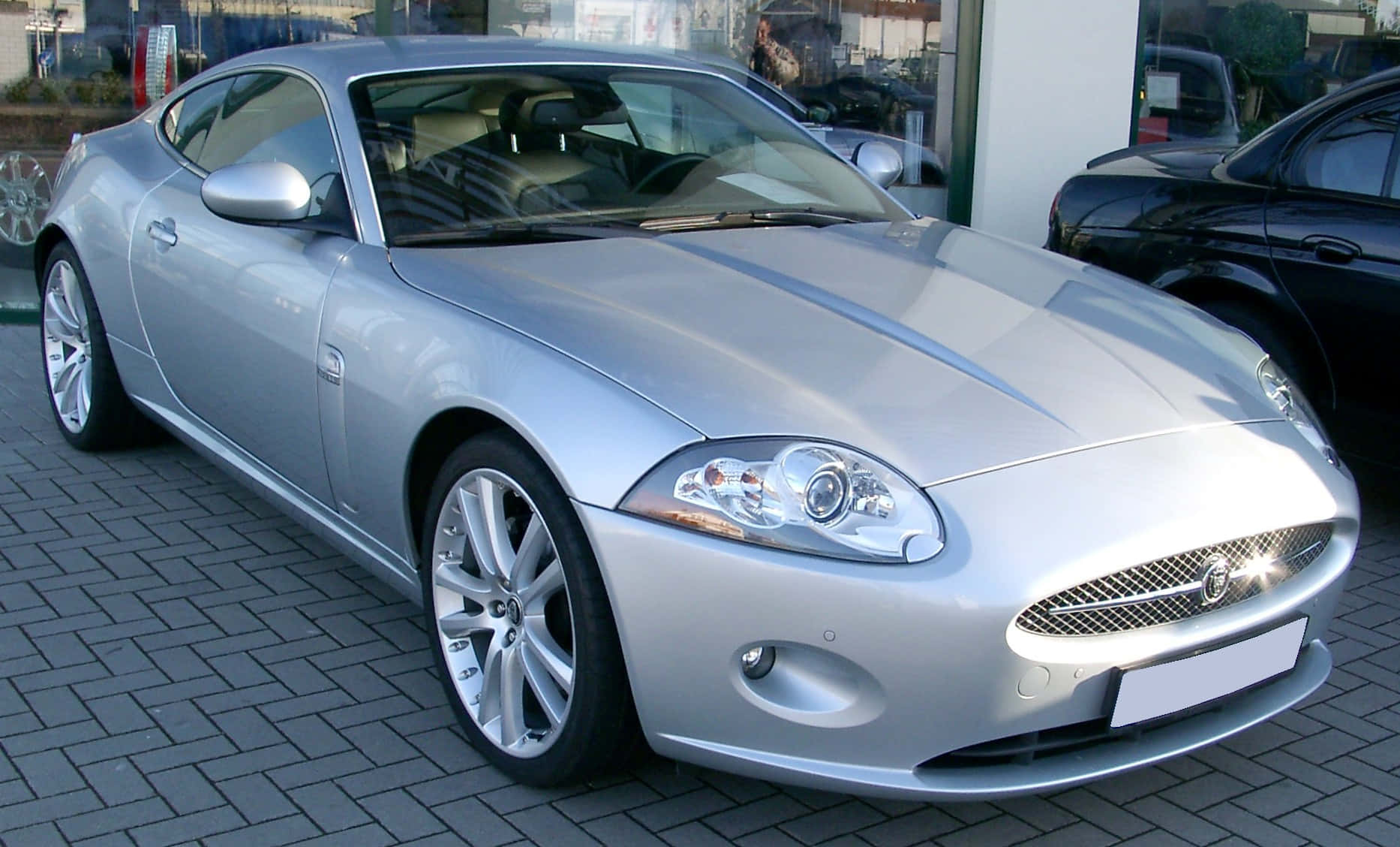 Sleek And Powerful Jaguar Xk In Motion Wallpaper