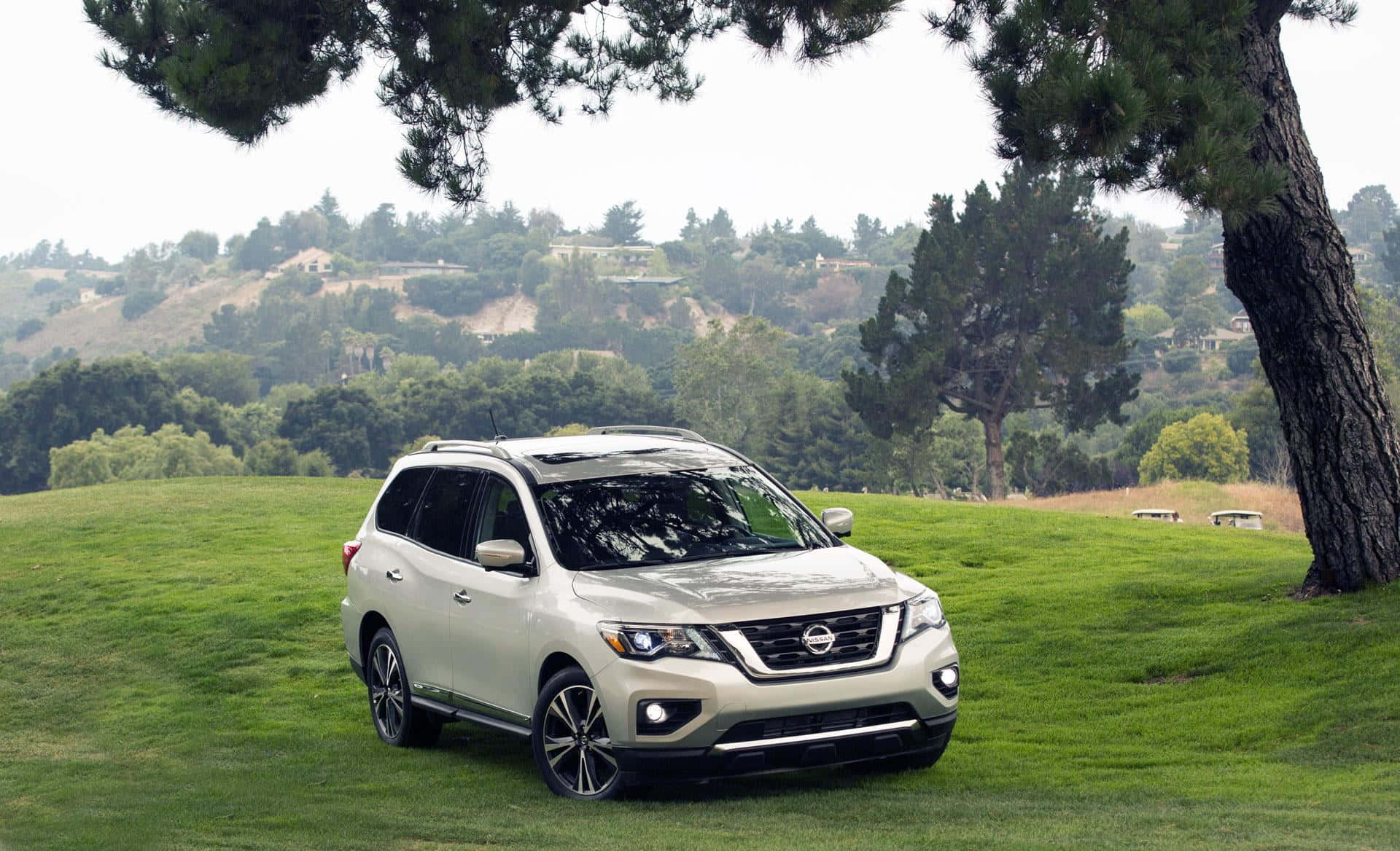 Sleek And Sophisticated Nissan Pathfinder Cruising On An Open Road Wallpaper