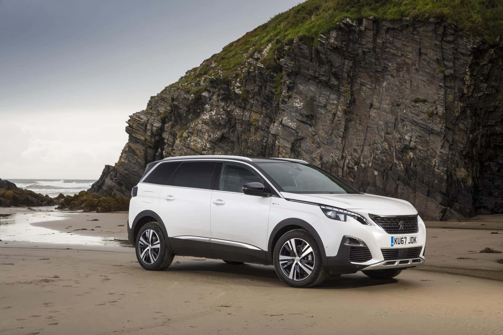Sleek And Sophisticated Peugeot 5008 In A City Landscape Wallpaper