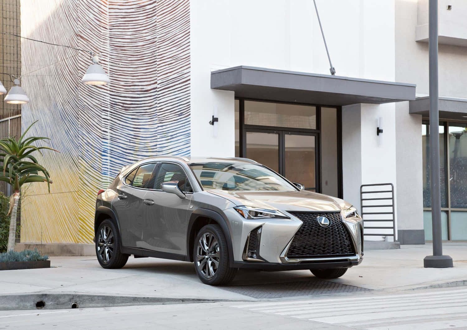 Sleek And Stylish Lexus Ux Navigating Smoothly On A City Street. Wallpaper