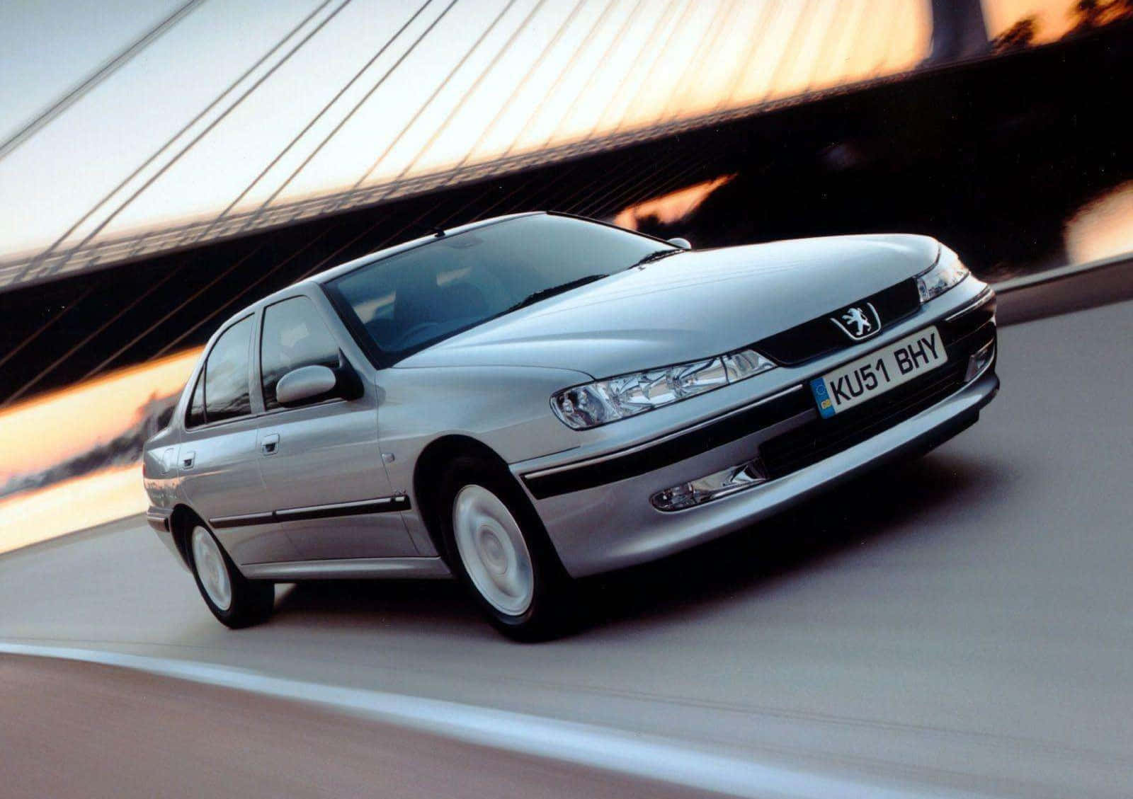 Sleek And Stylish Peugeot 406 In Motion Wallpaper