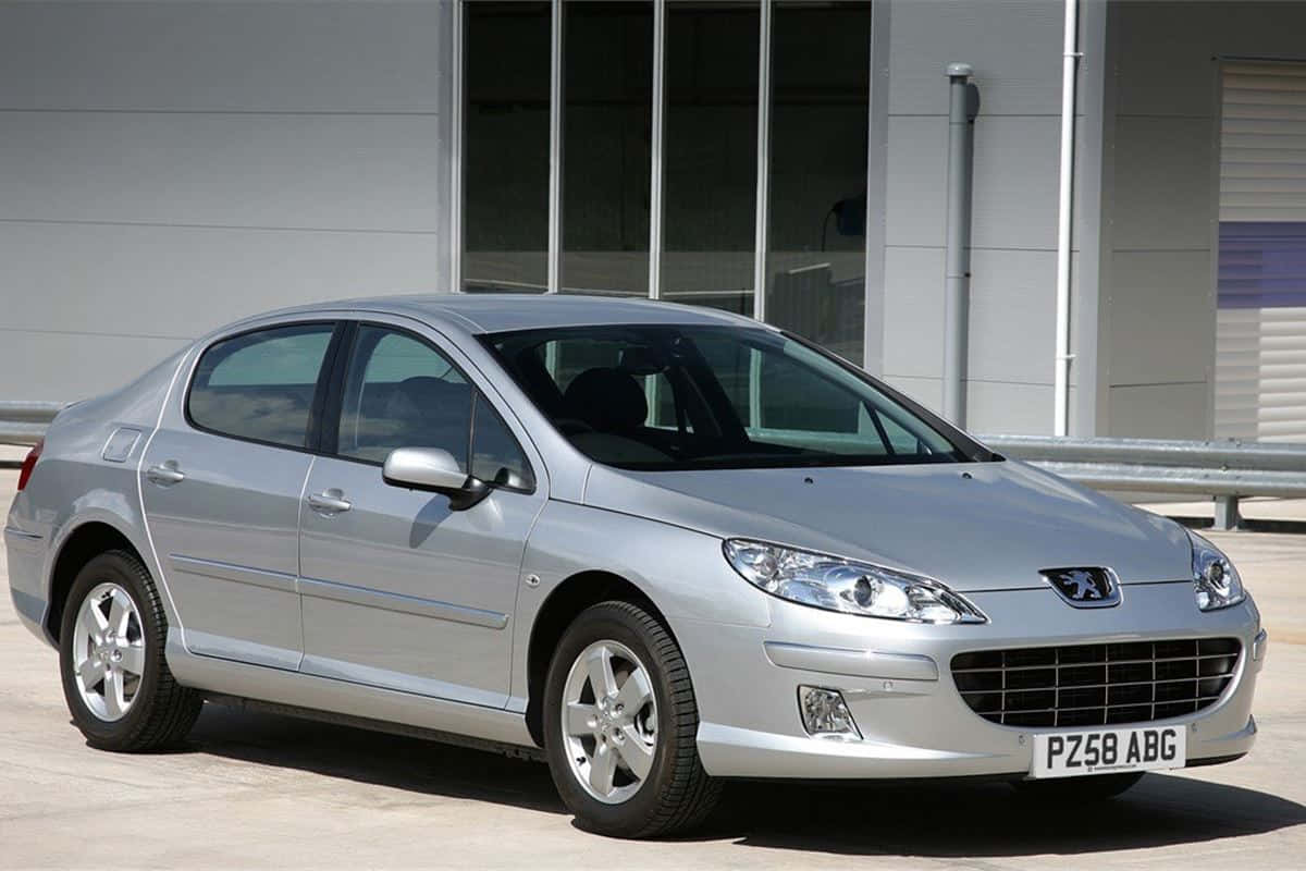 Sleek And Stylish Peugeot 407 On Scenic Drive Wallpaper