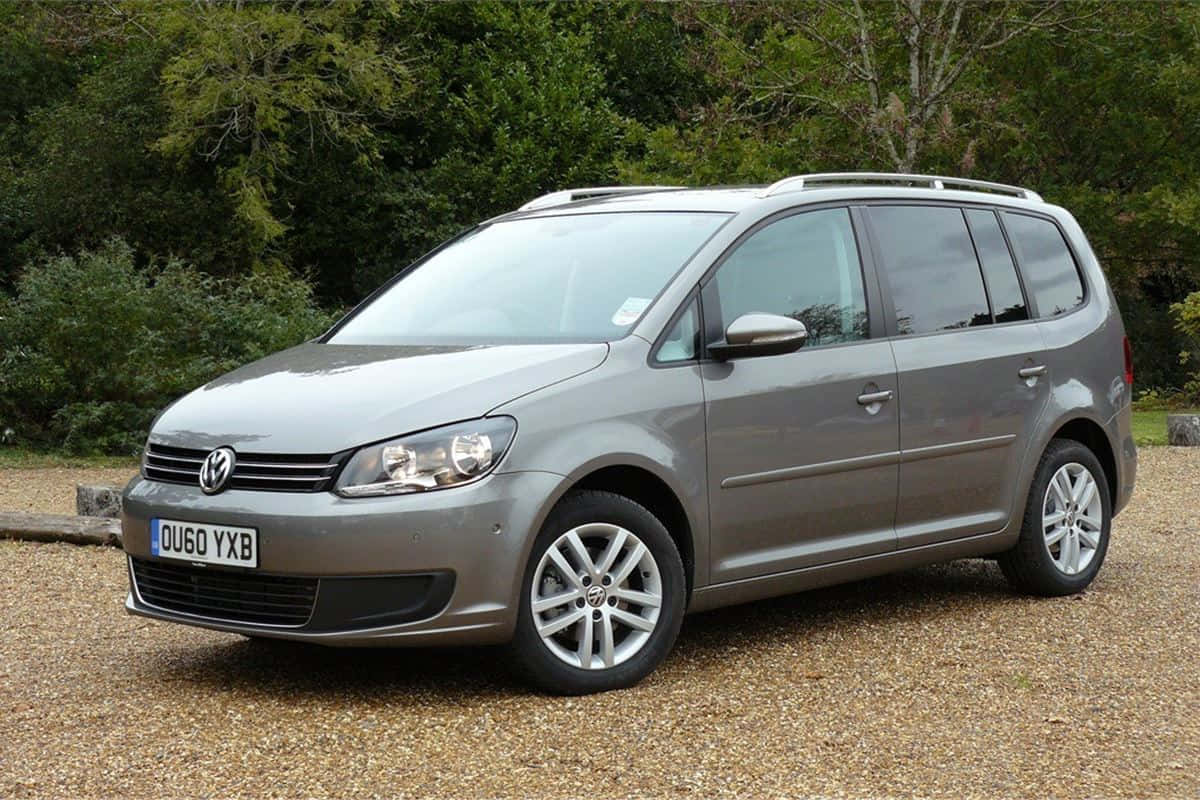 Sleek And Stylish Volkswagen Touran Gliding On An Open Road Wallpaper