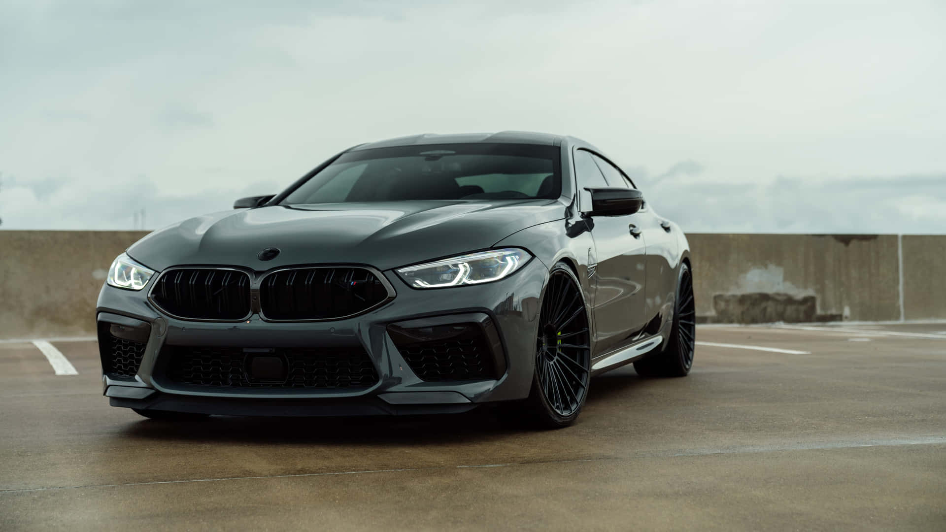 Sleek Black Coupe Parked Outdoors Wallpaper