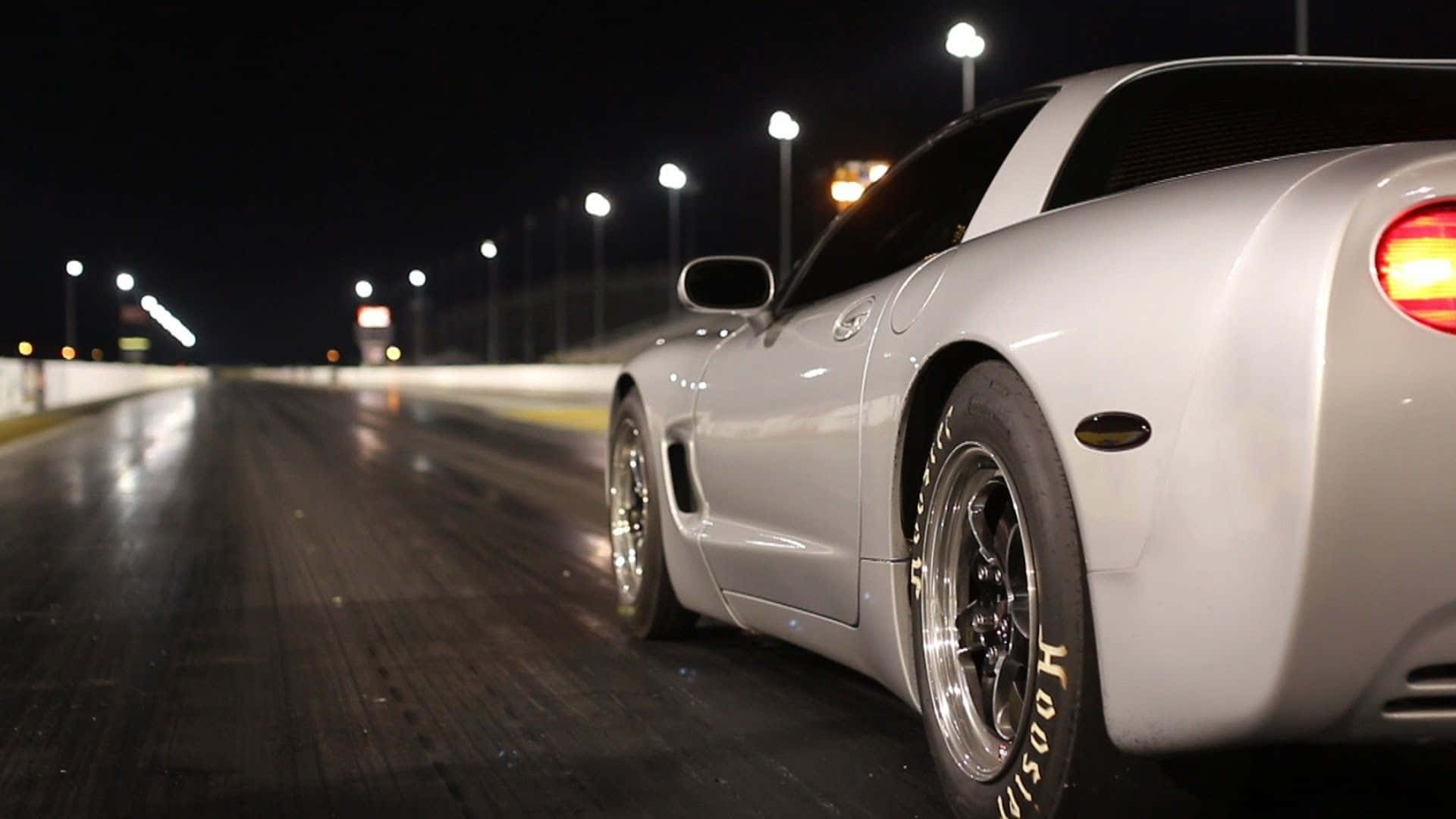 Sleek Chevrolet Corvette C5 Showcasing High Speed On An Open Road. Wallpaper