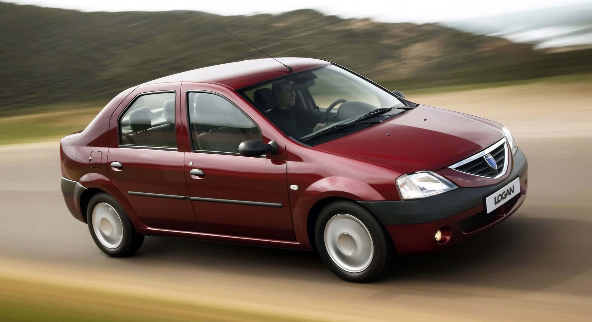 Sleek Dacia Logan In An Off-road Adventure Wallpaper