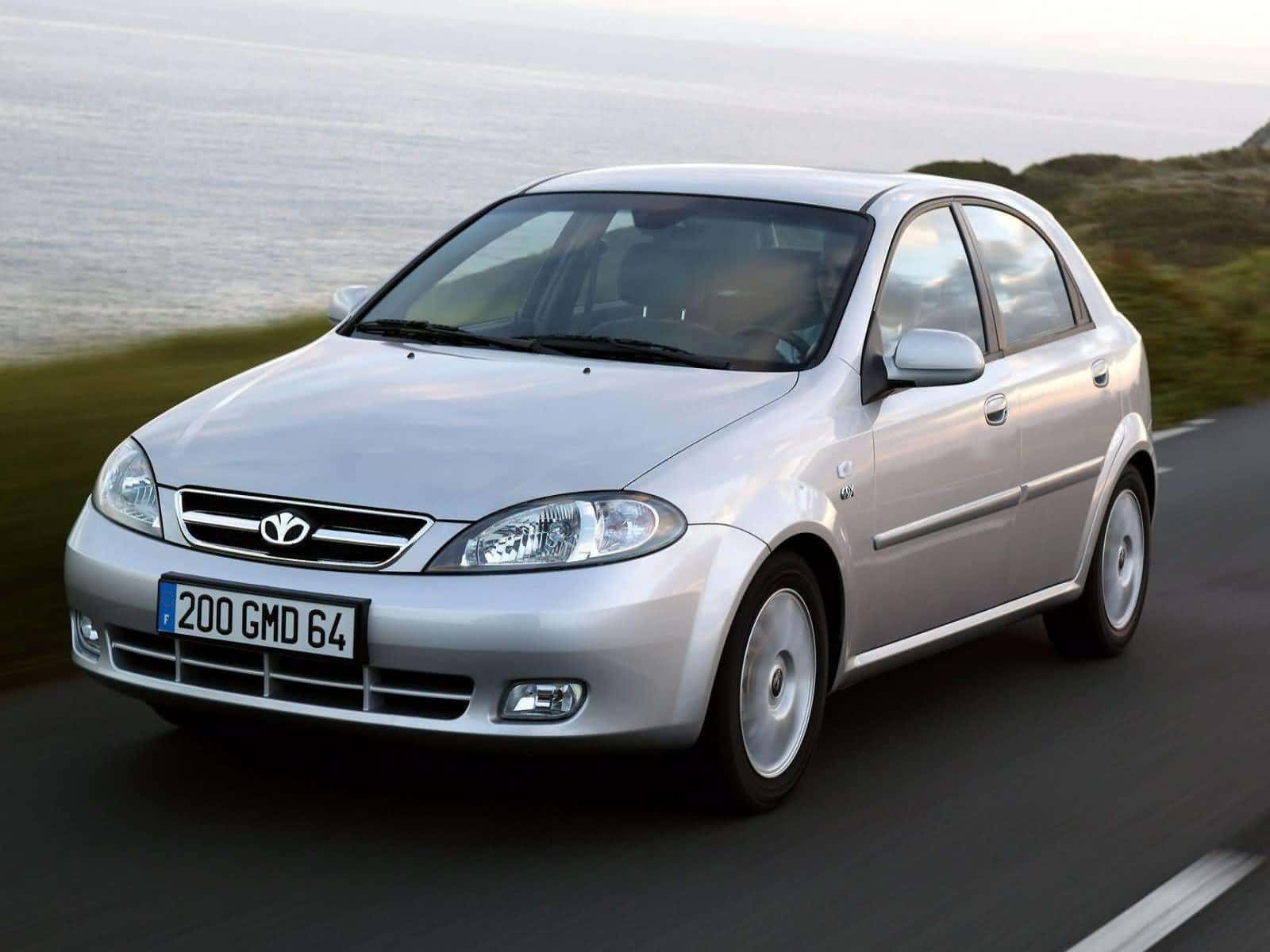 Sleek Daewoo Lacetti Cruising On The Highway Wallpaper