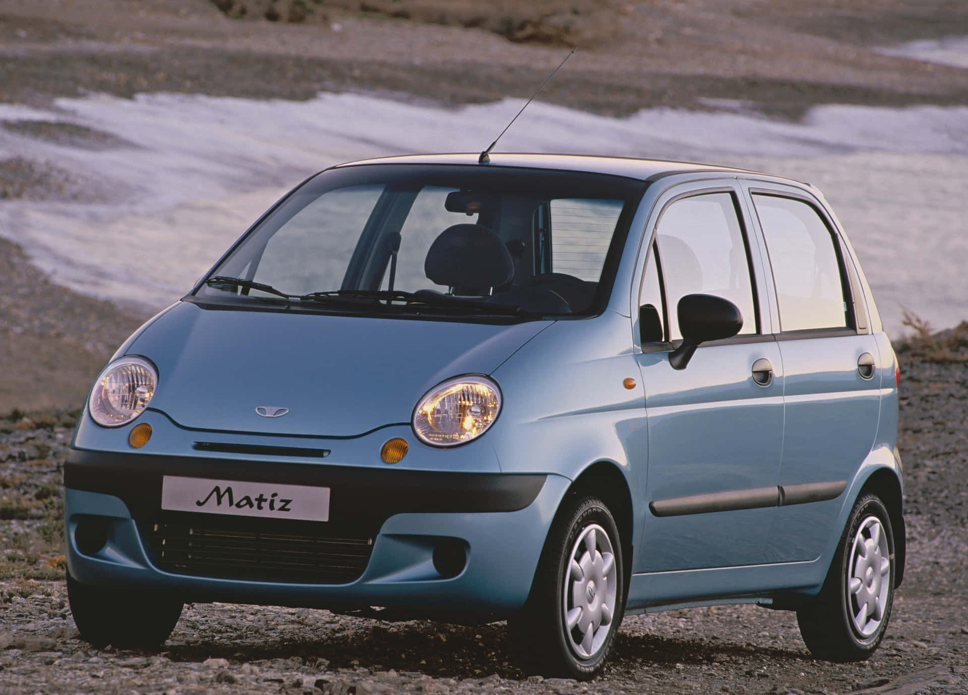 Sleek Daewoo Matiz Gliding On Glossy Streets Wallpaper