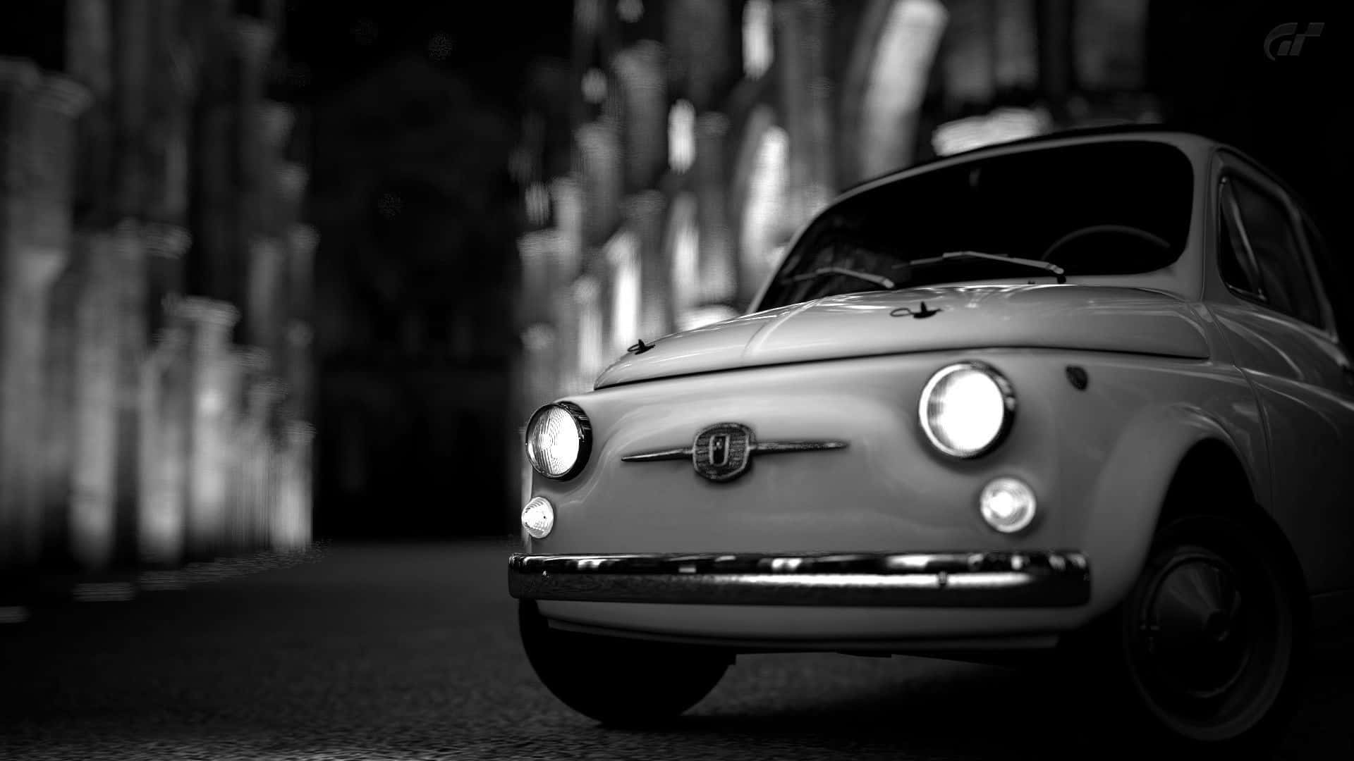 Sleek Fiat Cinquecento In Urban Backdrop Wallpaper