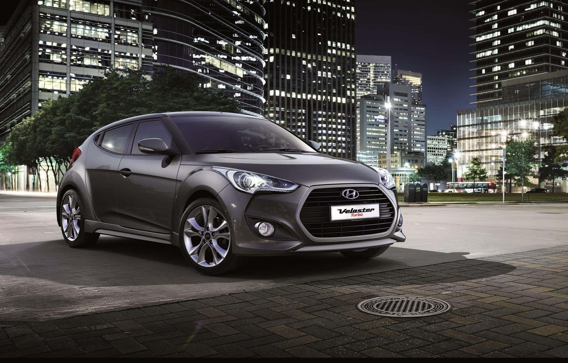 Sleek Hyundai Veloster In Action On The Road Wallpaper