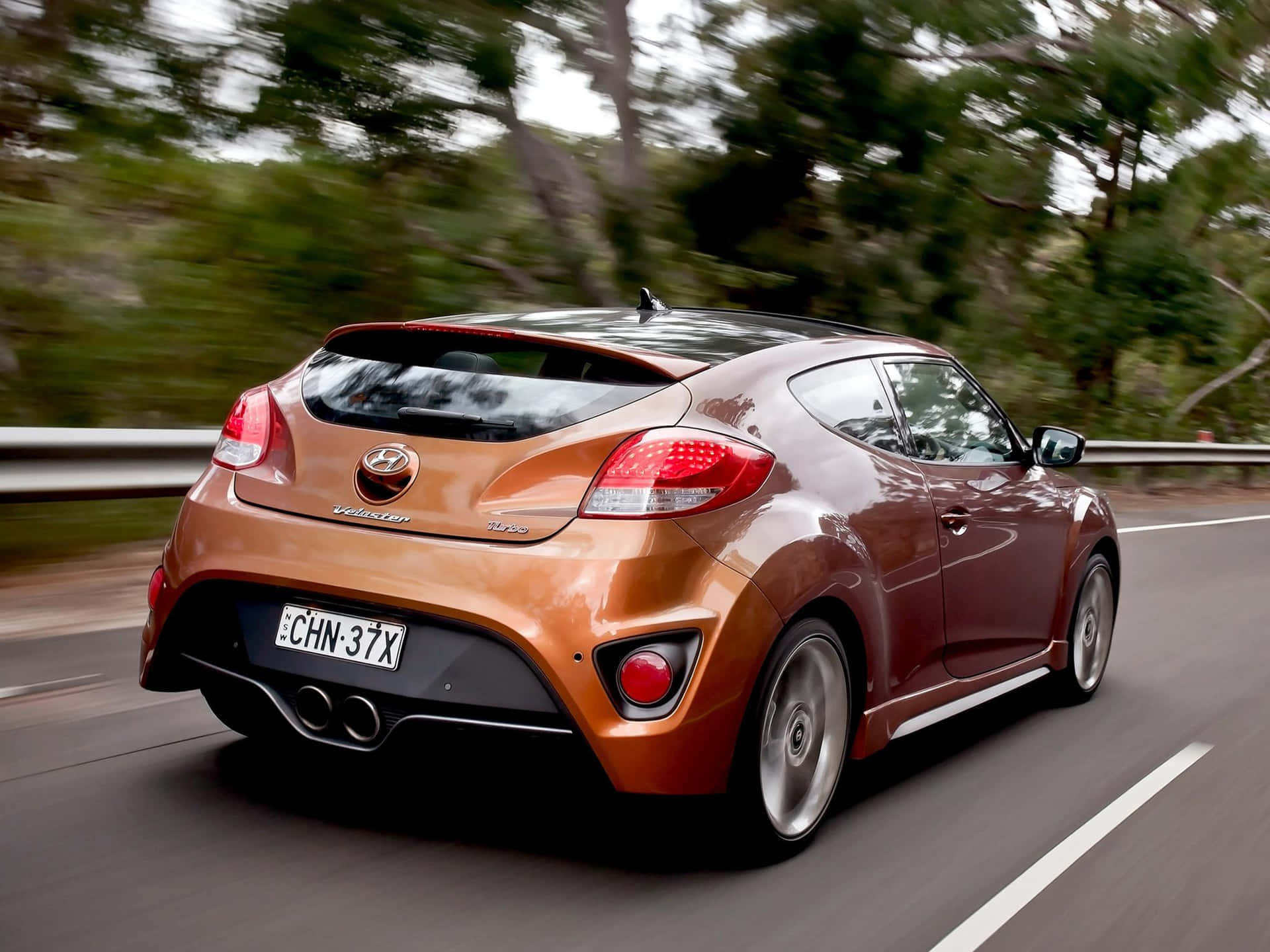 Sleek Hyundai Veloster In Urban Scenery Wallpaper