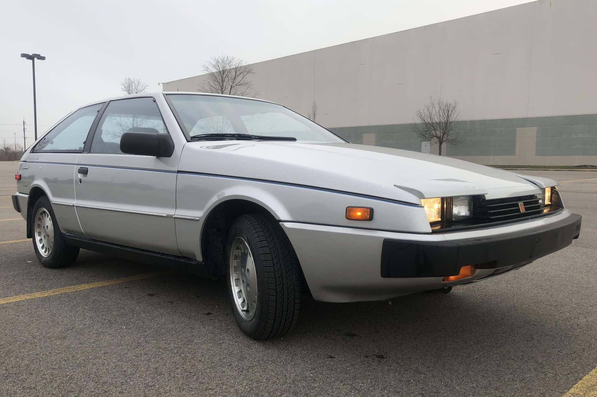 Isuzu Impulse Élégant Se Démarquant Dans Une Rue De La Ville Fond d'écran