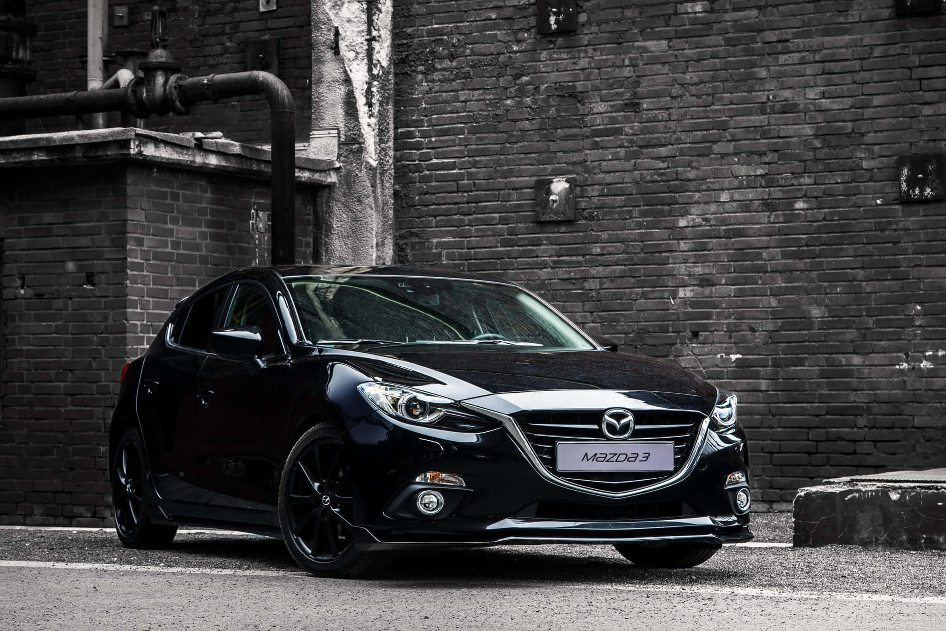 Sleek Mazda 3 Hatchback In Urban Setting Wallpaper