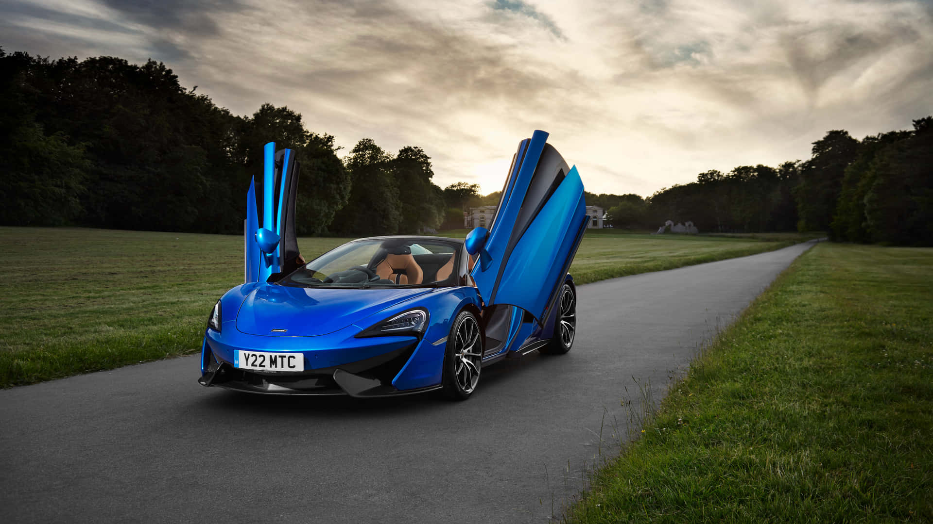 Sleek Mclaren 570s Sports Car In Dynamic Action Wallpaper