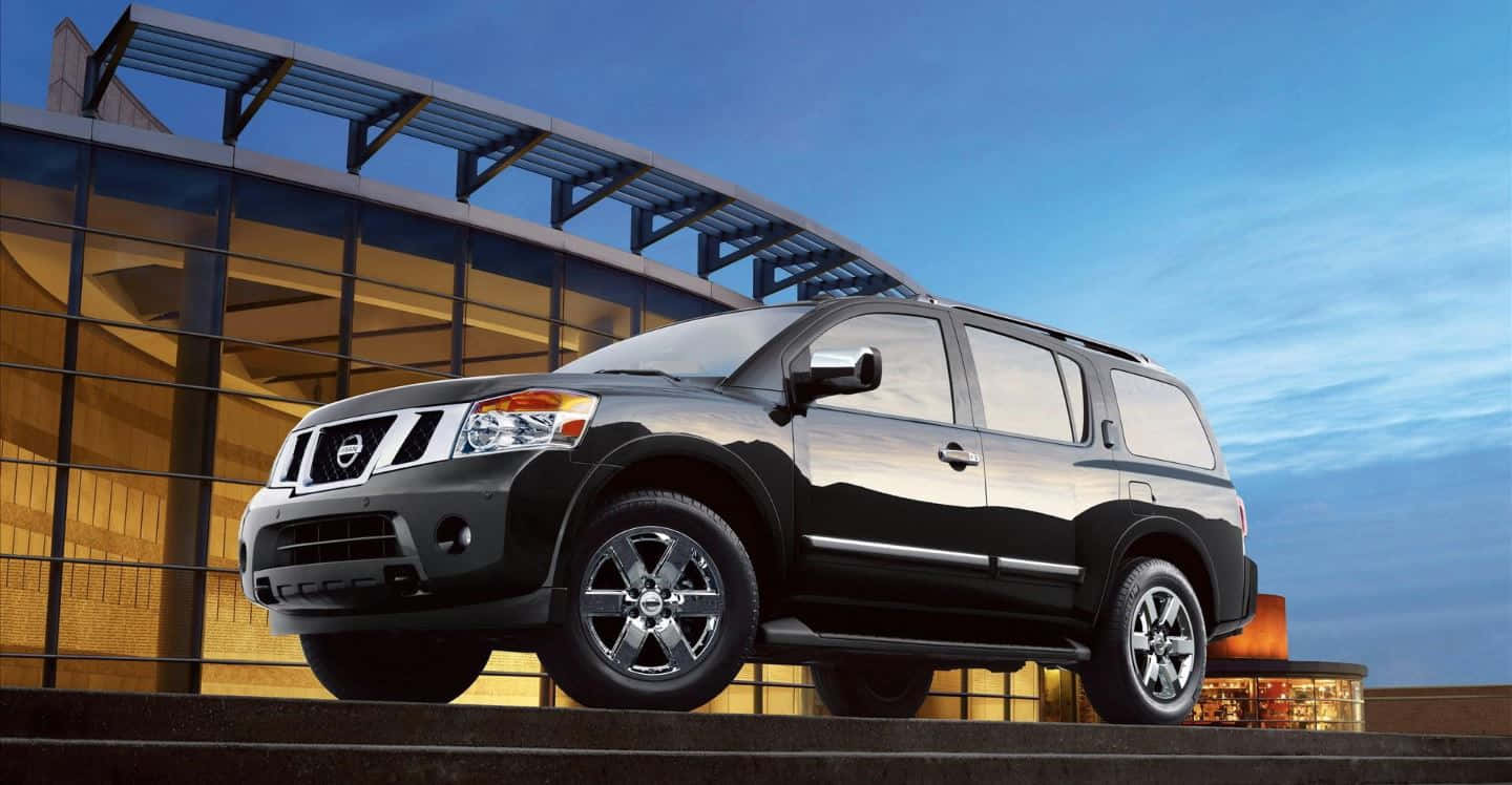 Sleek Nissan Armada Cruising On The Highway Wallpaper