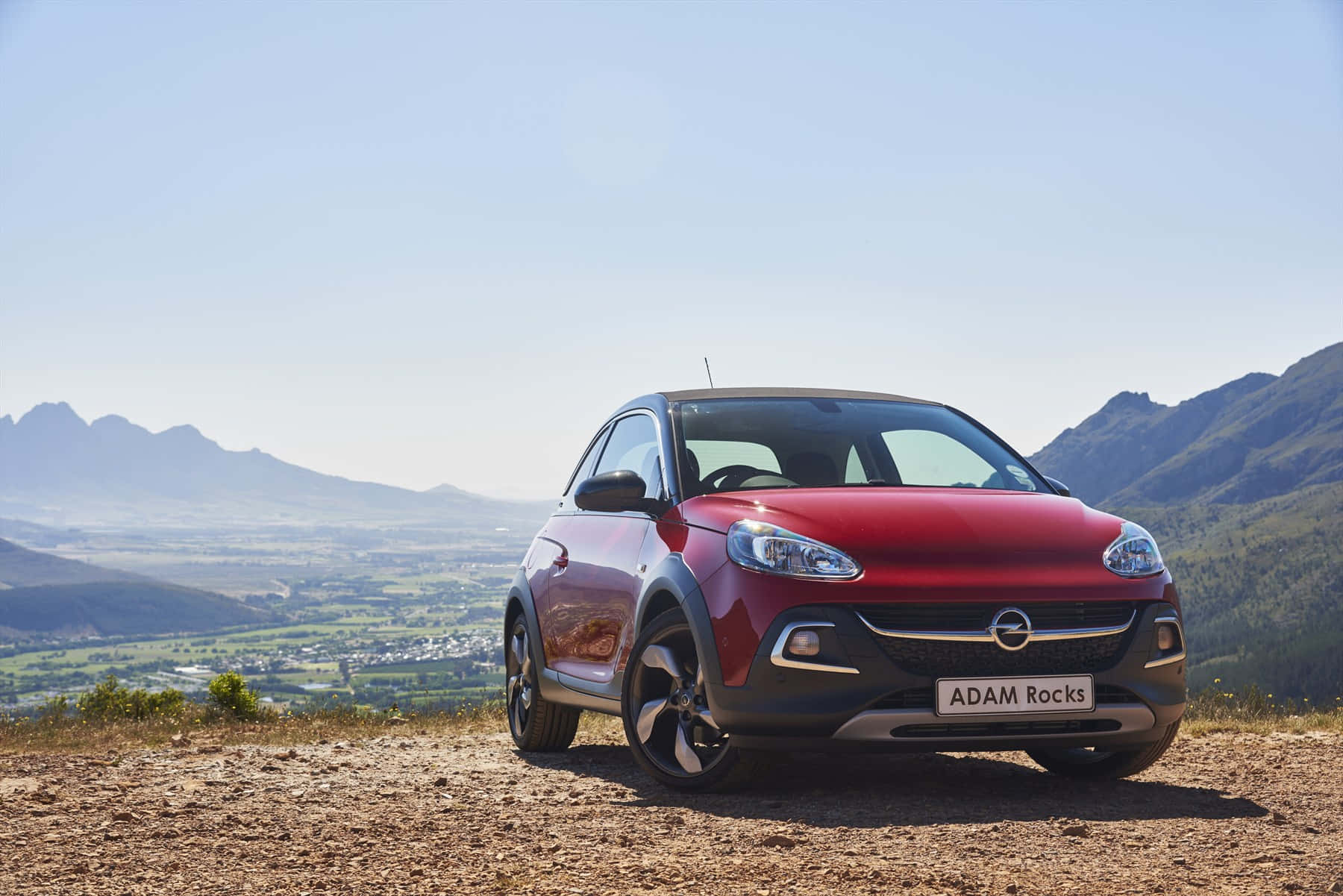 Sleek Opel Adam I Livlig By Miljø Bakgrunnsbildet