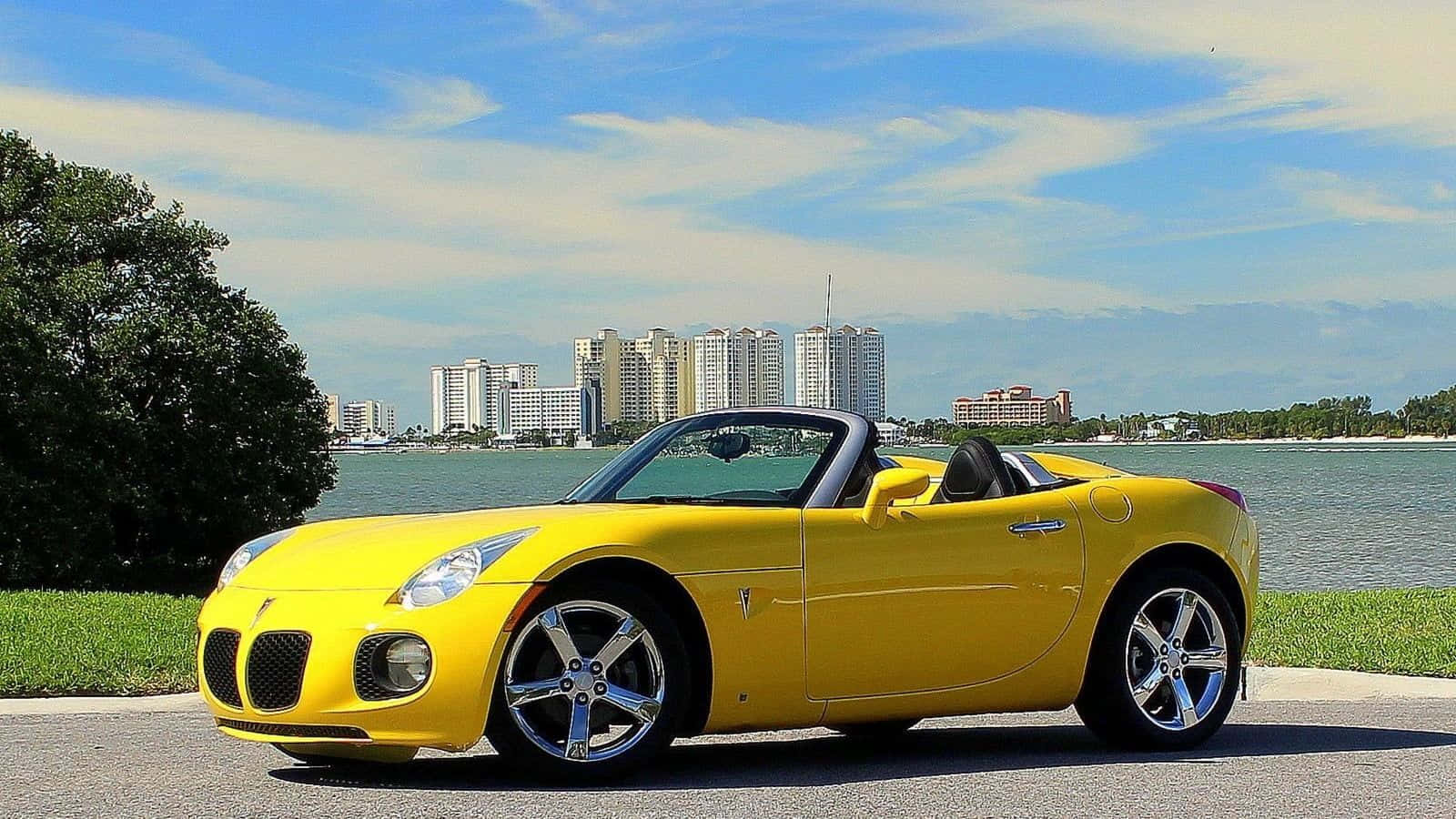 Sleek Pontiac Solstice On The Road Wallpaper