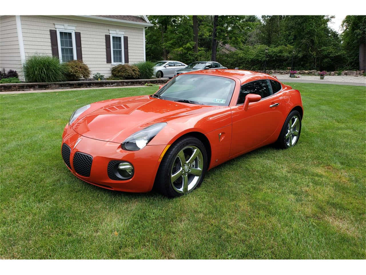 Sleek Pontiac Solstice On The Road Wallpaper