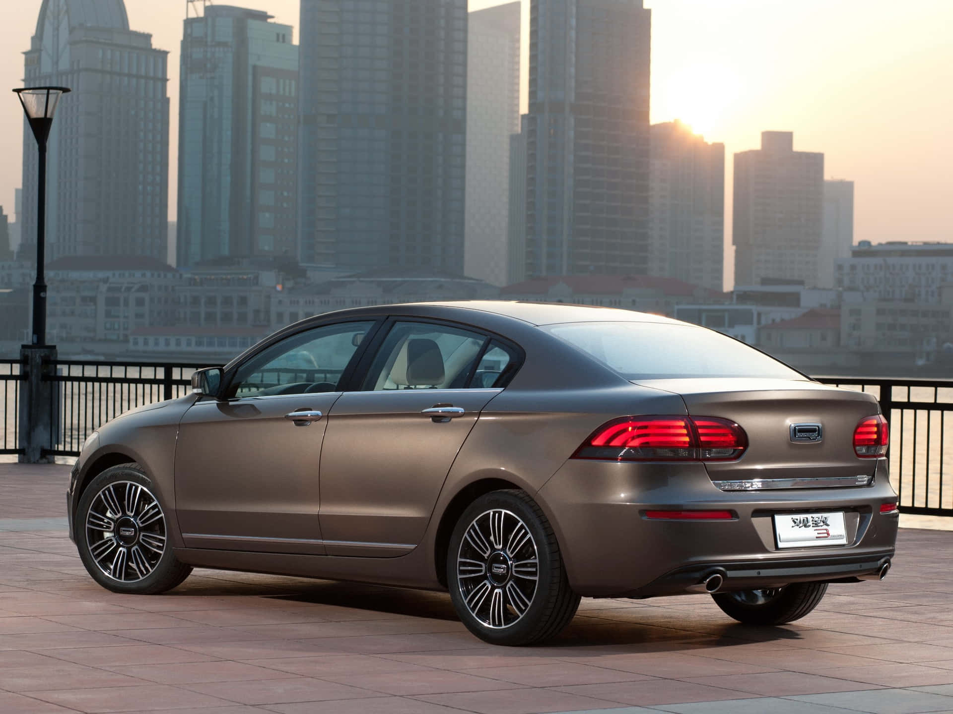 Sleek Qoros 3 Sedan In Urban Setting Wallpaper