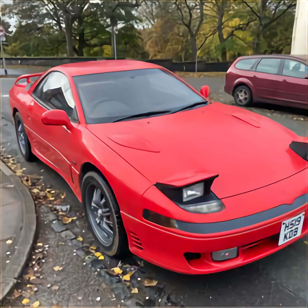 Sleek Red Pontiac Fiero Under The Sunset Wallpaper