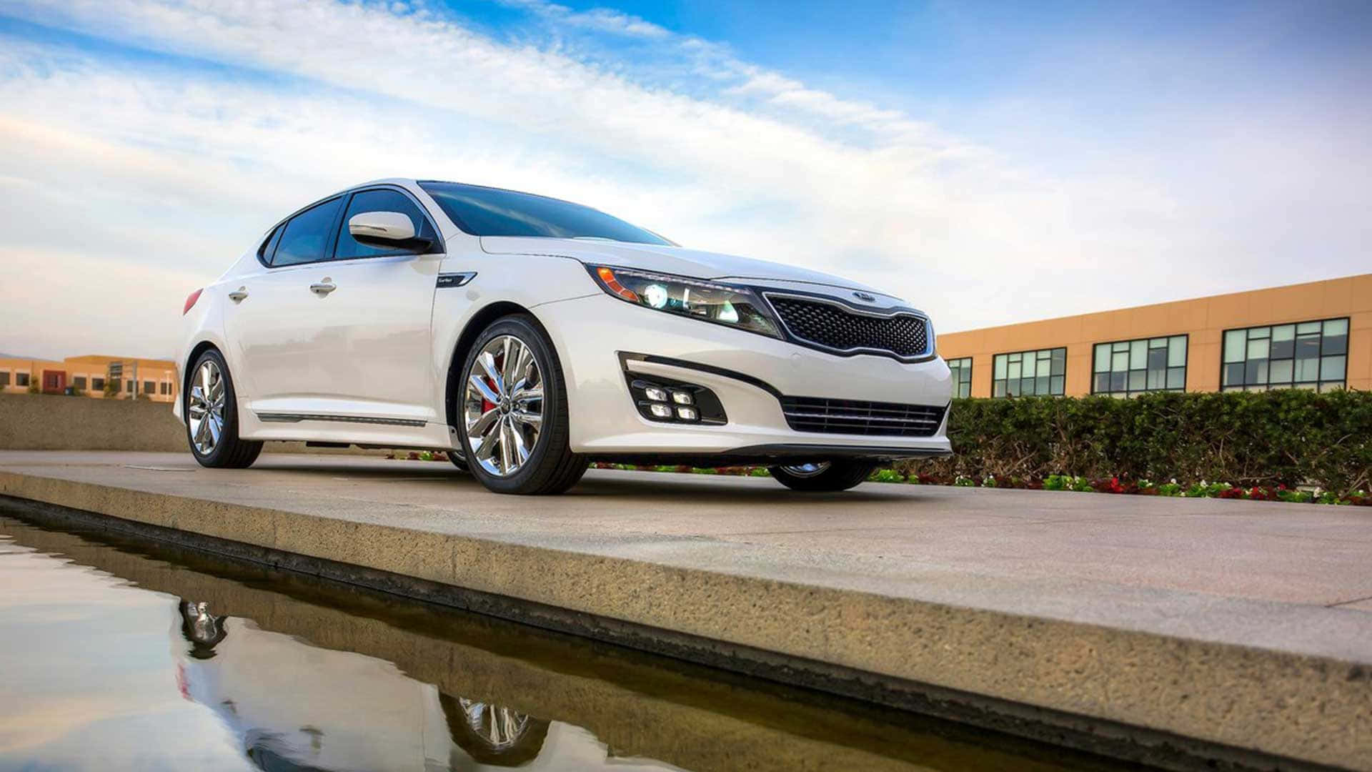 Sleek Silver Kia Optima Parked Outdoors Wallpaper