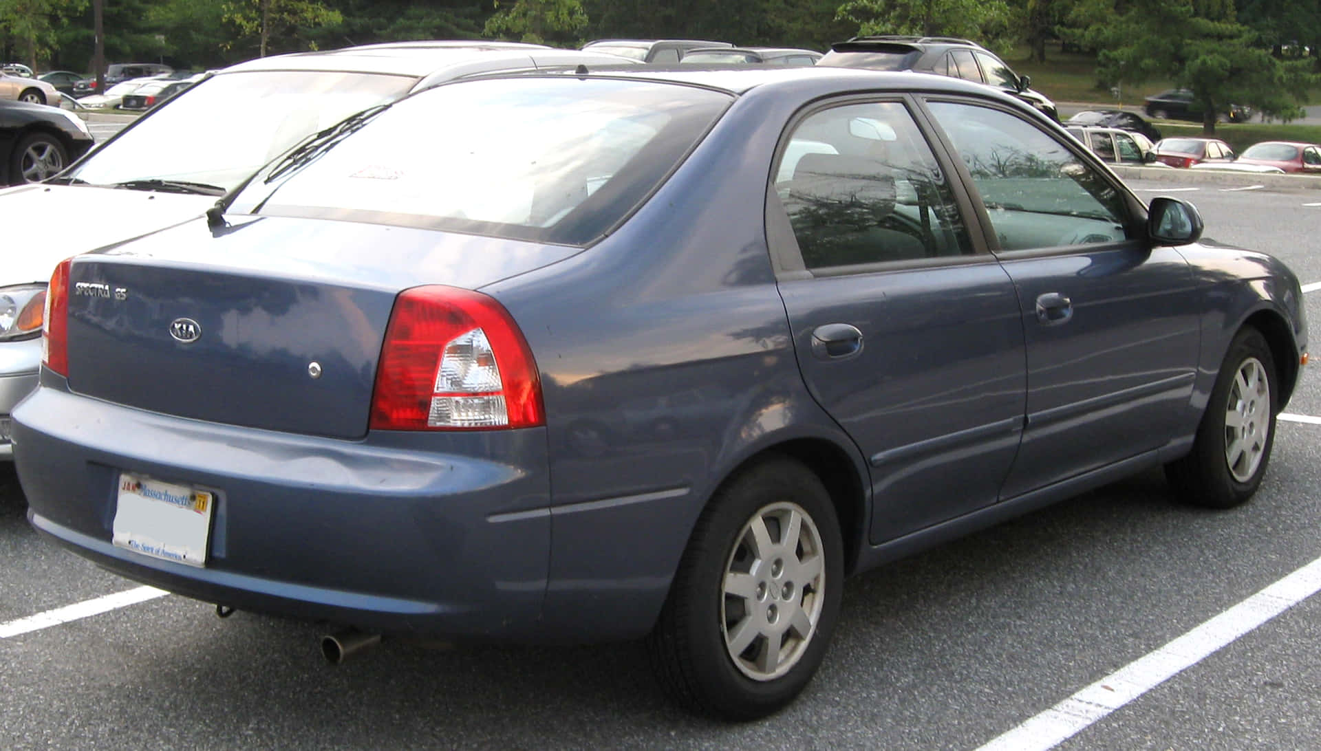 Sleek Silver Kia Spectra On The Road Wallpaper