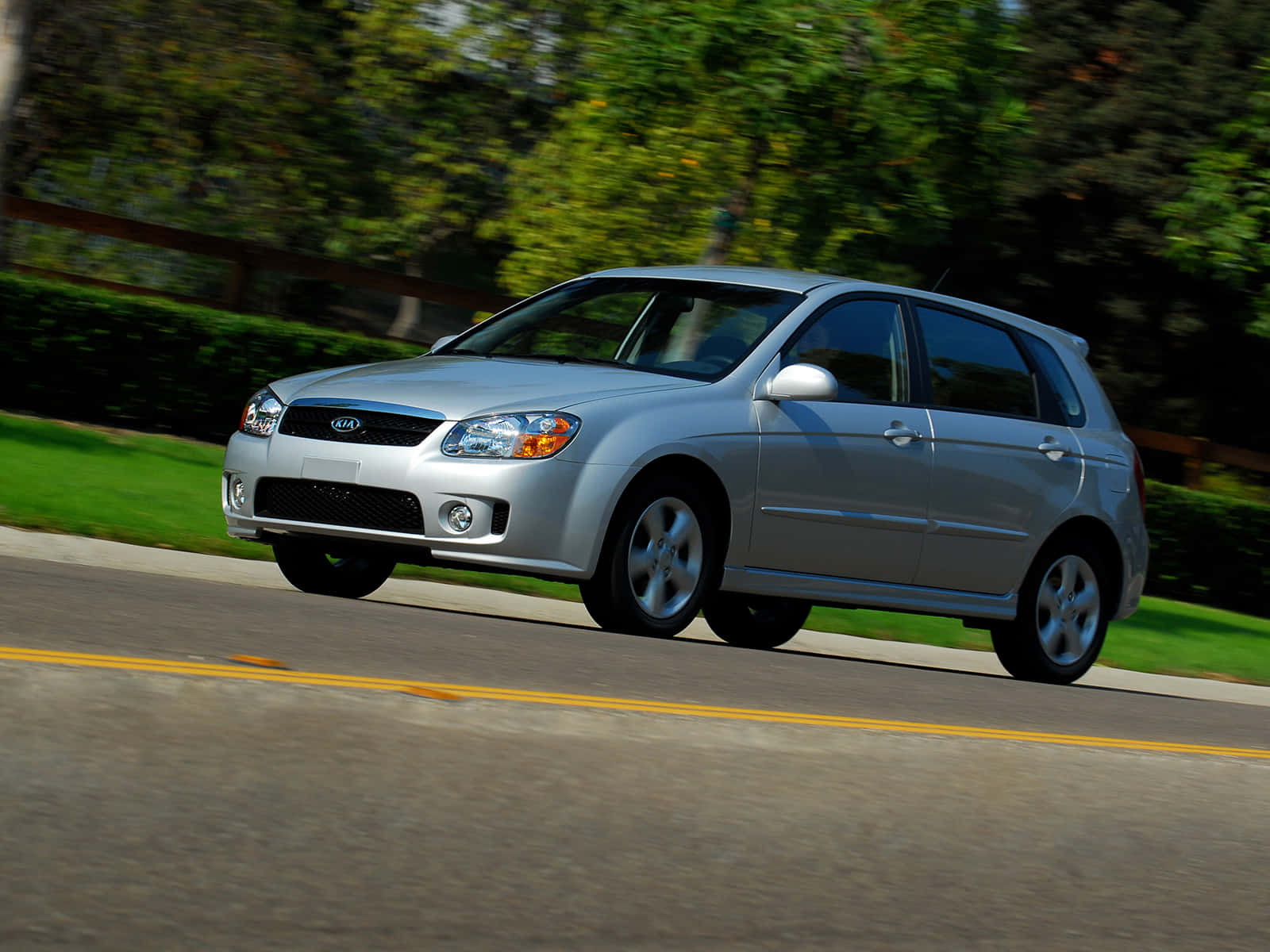 Sleek Silver Kia Spectra Sedan In Urban Setting Wallpaper