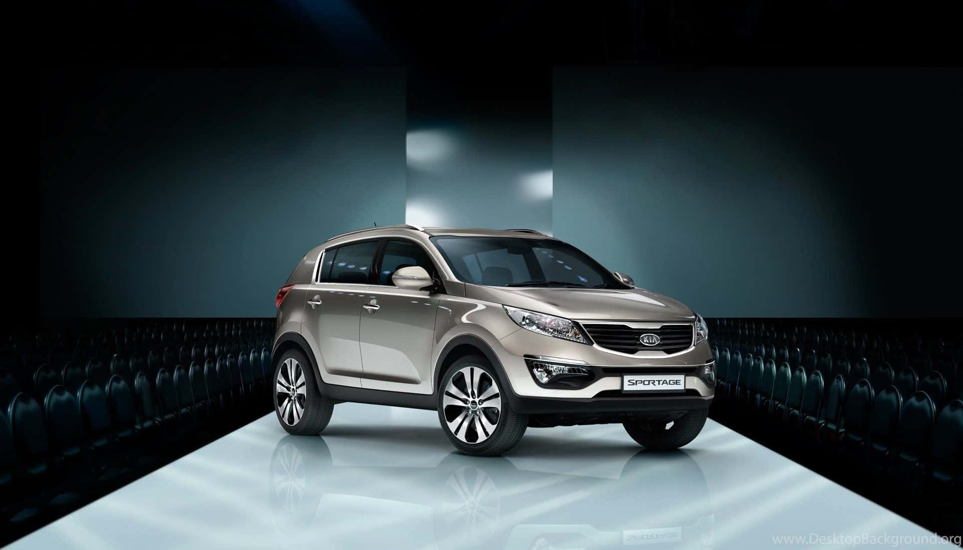 Sleek Silver Kia Sportage Cruising On A Highway Wallpaper