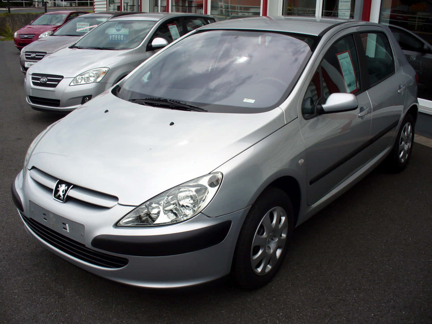 Sleek Silver Peugeot 307 Standing Out Against A Vast Landscape Wallpaper