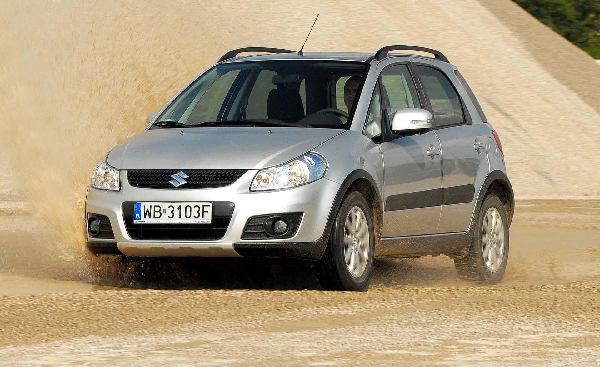 Sleek Silver Suzuki Sx4 Displaying Superior Vehicle Dynamics Wallpaper