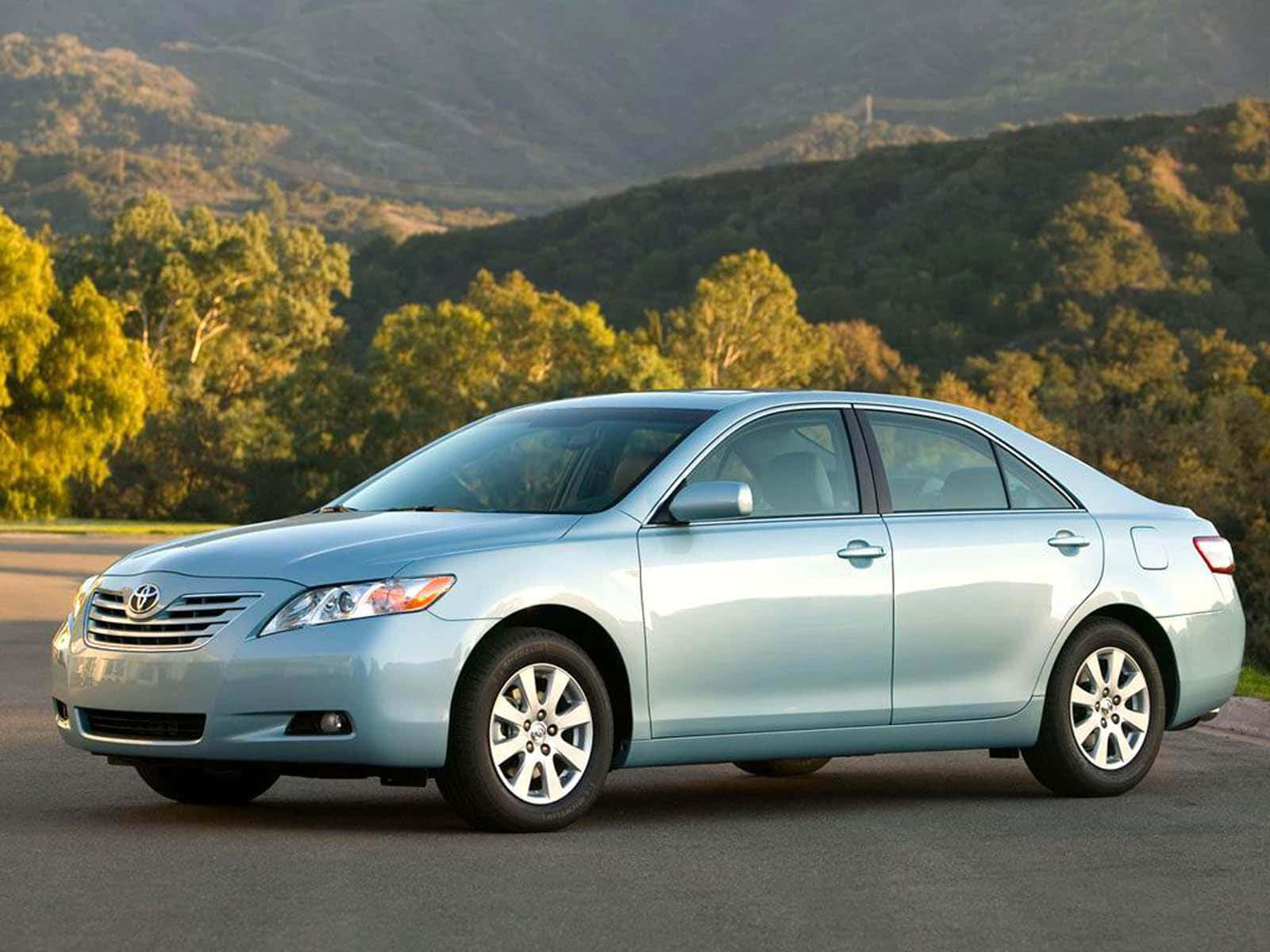 Sleek Silver Toyota Camry On Scenic Road Trip Wallpaper