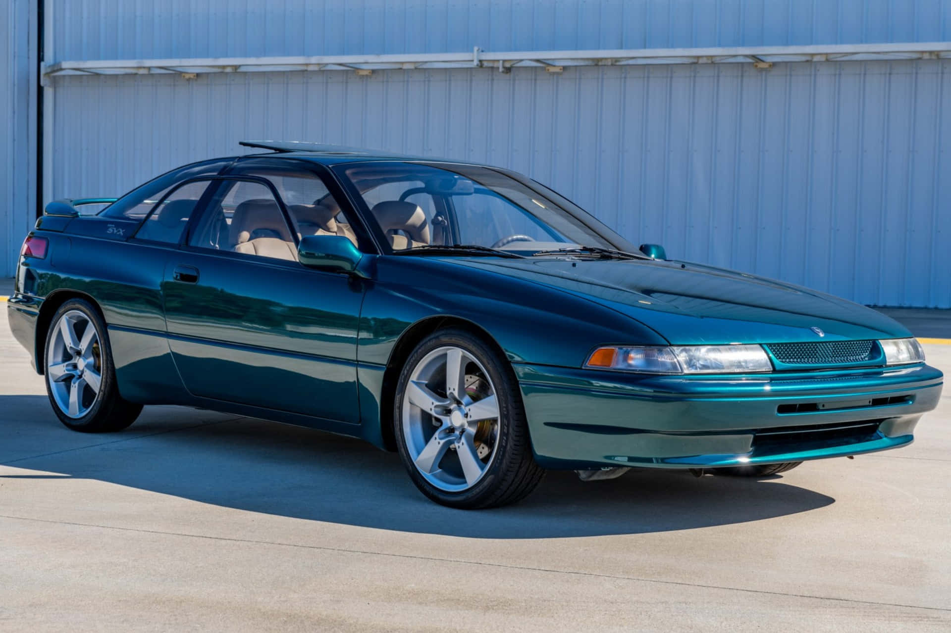 Sleek Subaru Svx Cruising On The Open Road Wallpaper