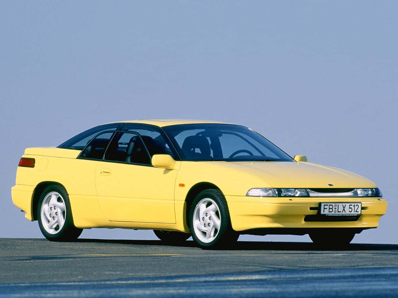 Sleek Subaru Svx Demonstrating Its Majestic Design On The Road Wallpaper