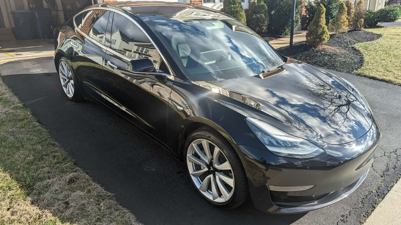 Sleek Tesla Model 3 In A Dynamic Road Scenario Wallpaper