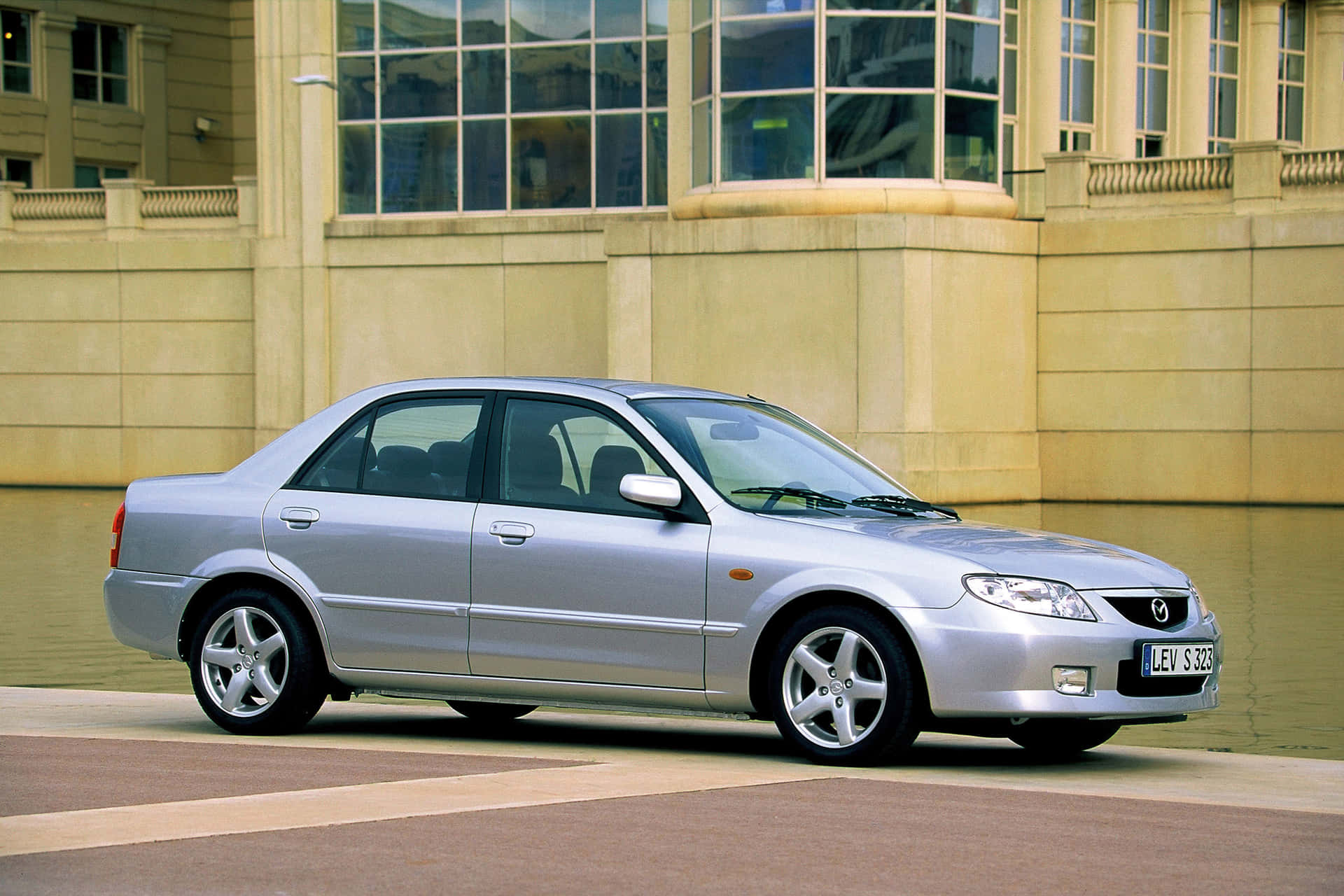 Sleek Vintage Mazda 323 In Pristine Condition Wallpaper