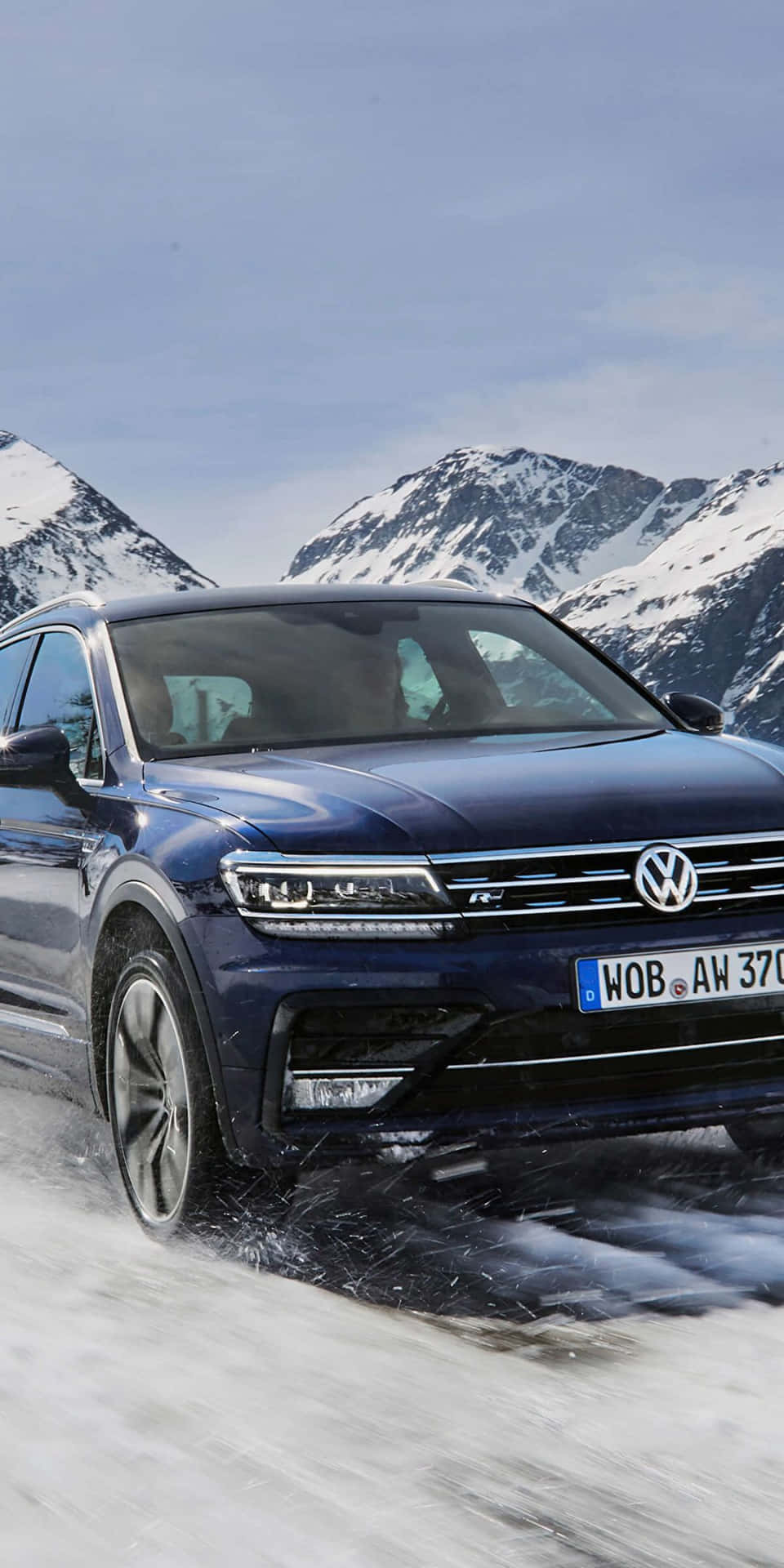 Sleek Volkswagen Tiguan In Snowy Terrain Wallpaper