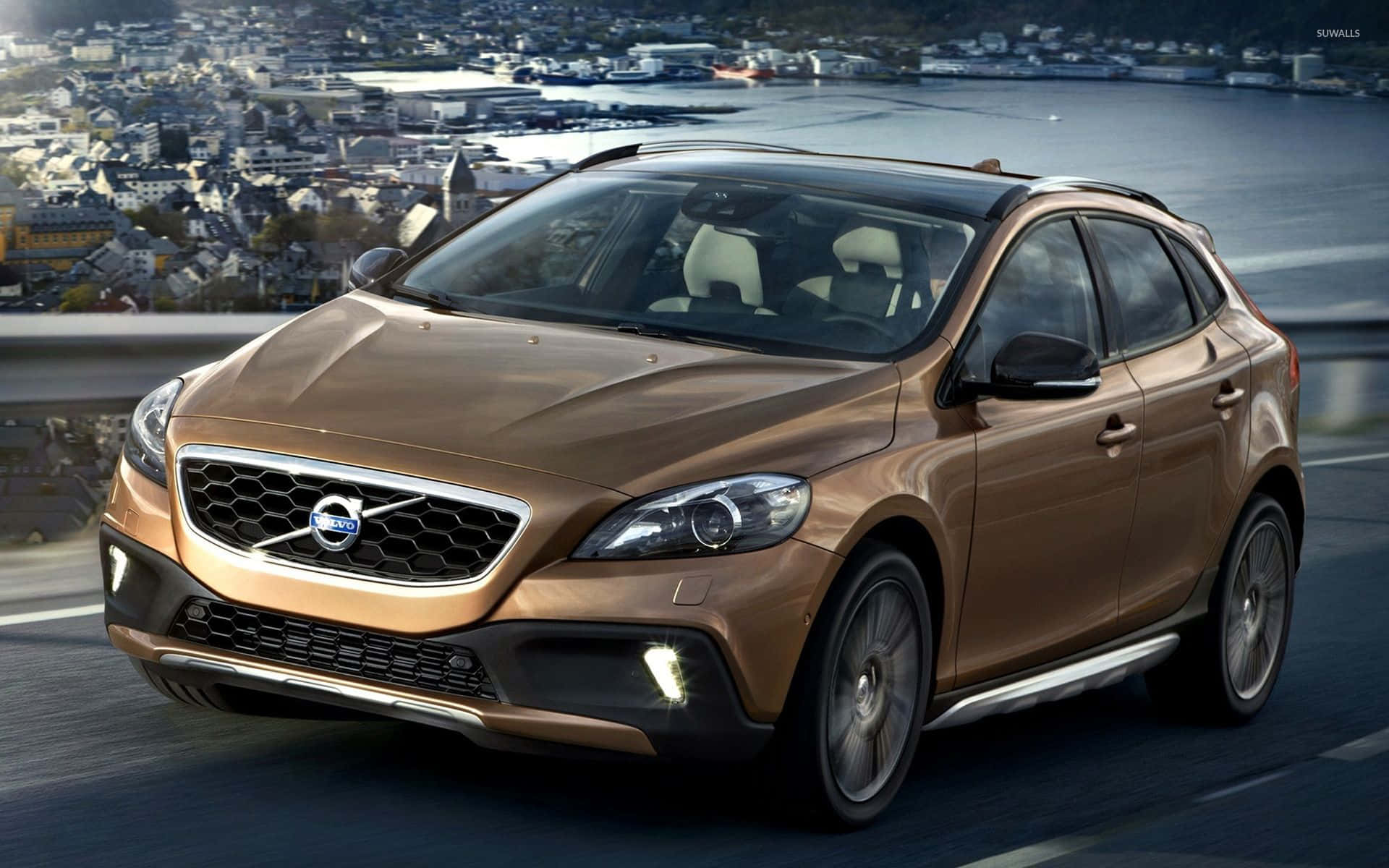 Sleek Volvo V40 Cruising On The Highway Wallpaper