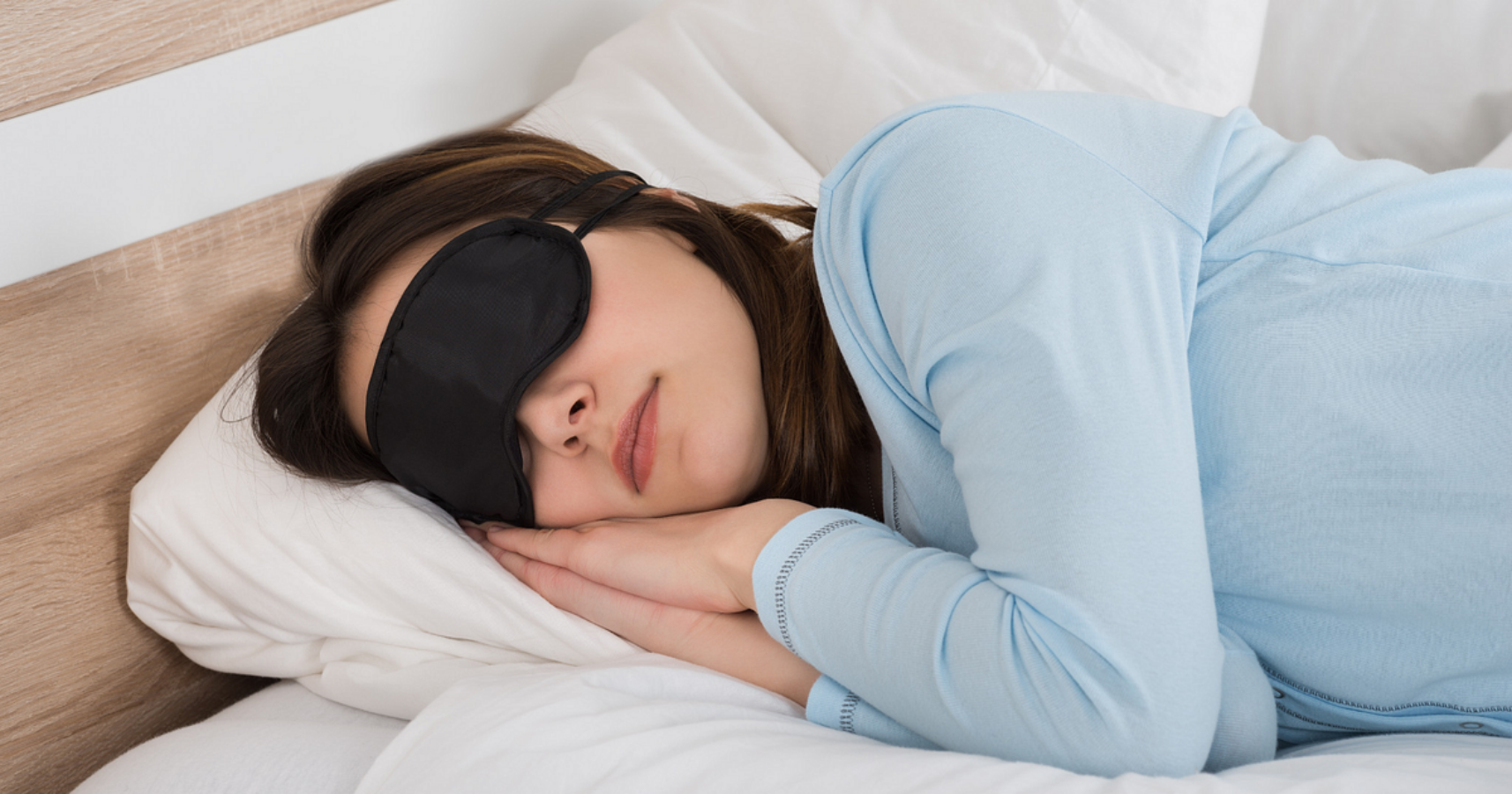 A Woman Sleeping With A Black Eye Mask