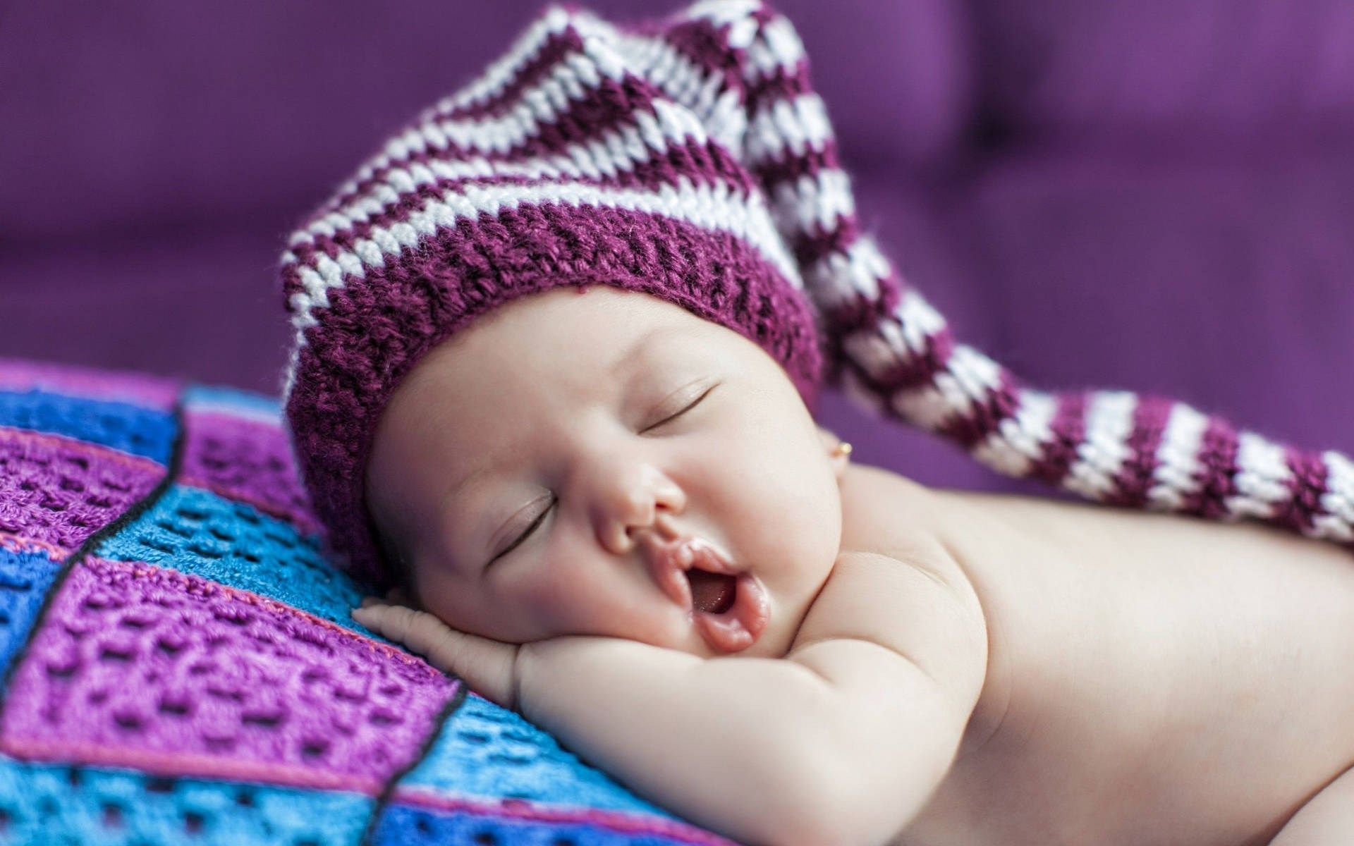 Sleeping Baby Wearing Purple Crochet Bonnet Wallpaper